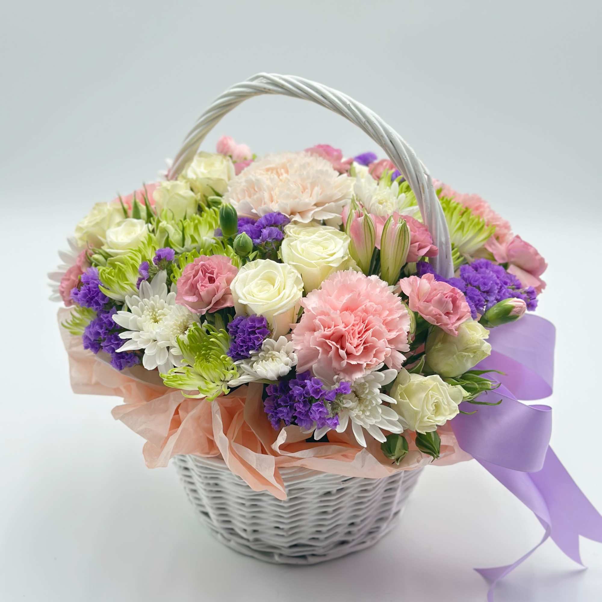 A charming little flower basket made of fresh, delicate blooms — the A charming little flower basket made of fresh, delicate blooms — the