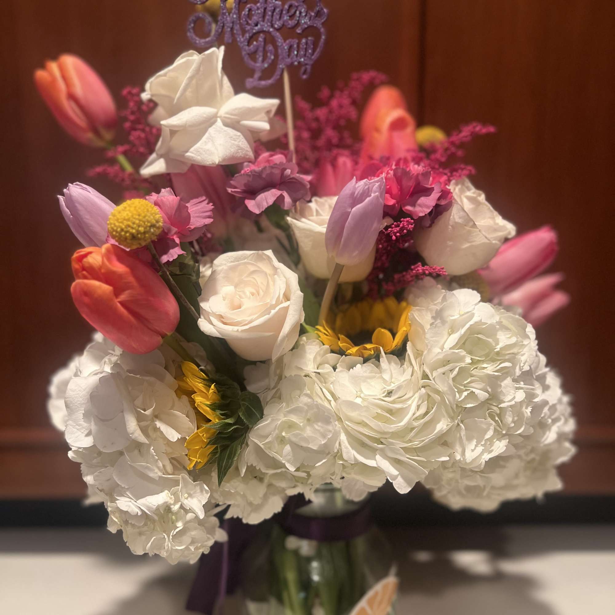 This arrangement includes hydrangea, tulips, freesia, succulents and other seasonal blooms. This