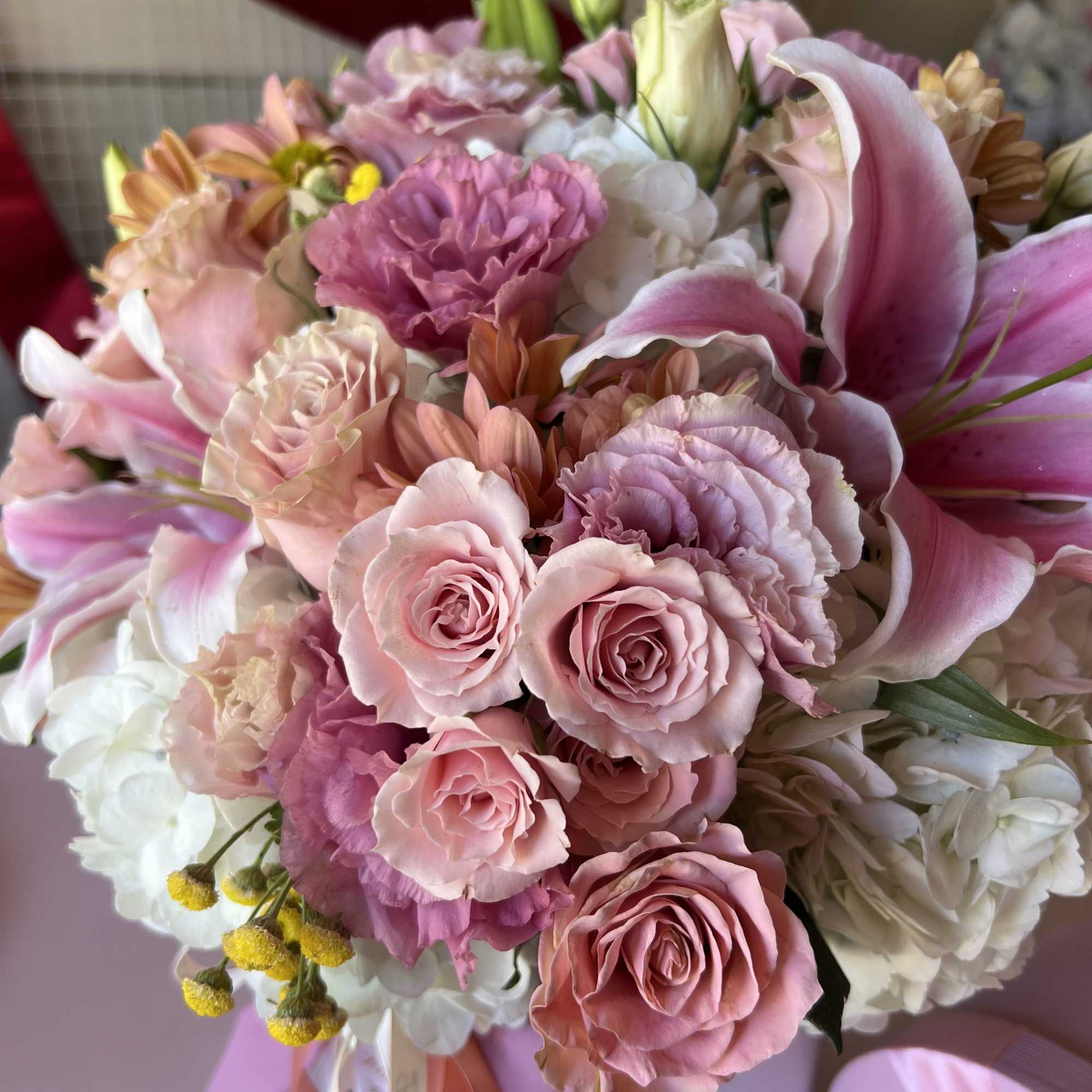Cylinder with hydrangeas, Roses, Lilies, Lisianthus, Spray Roses.