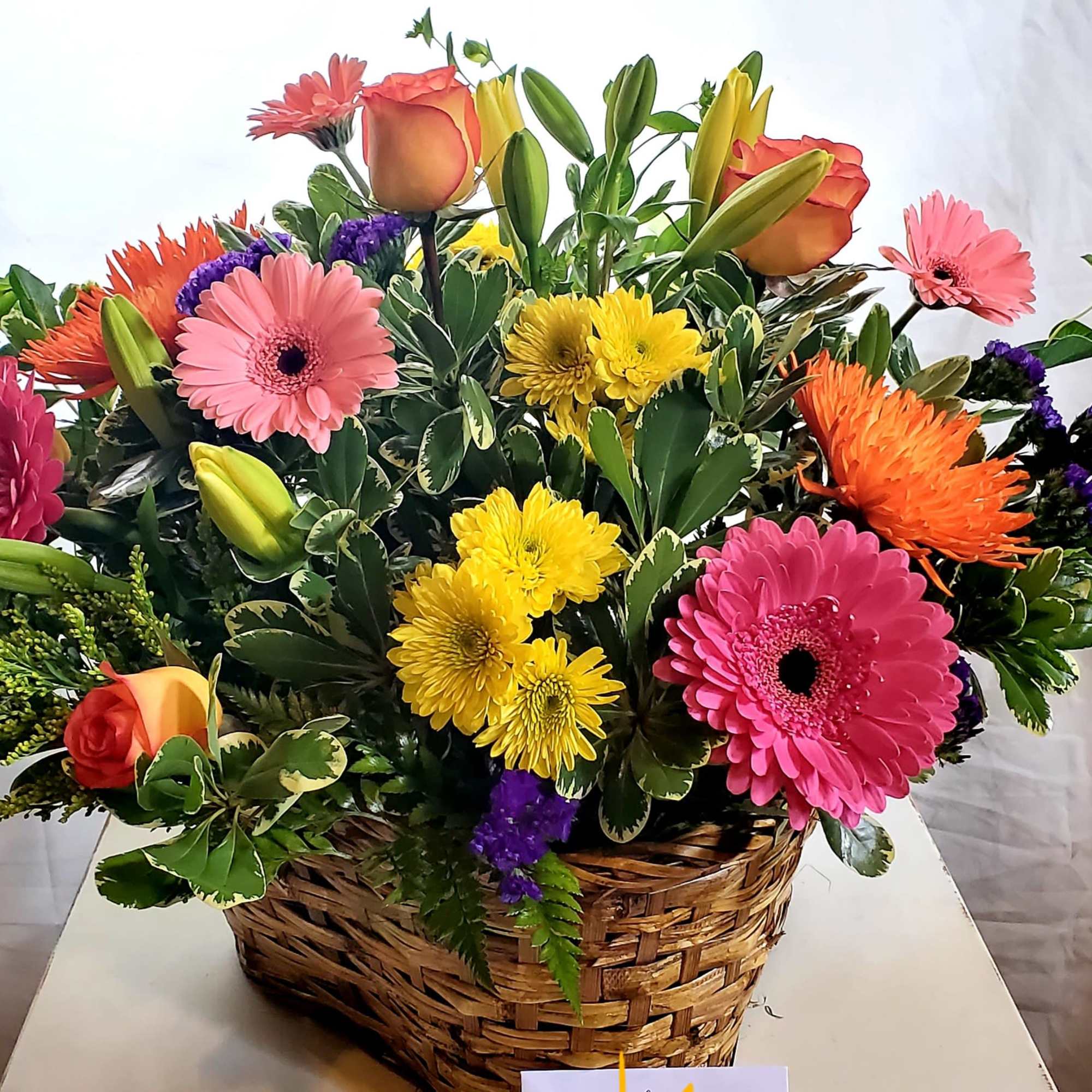 An elegant bright basket for any occasion.  Enjoy seasonal blooms in