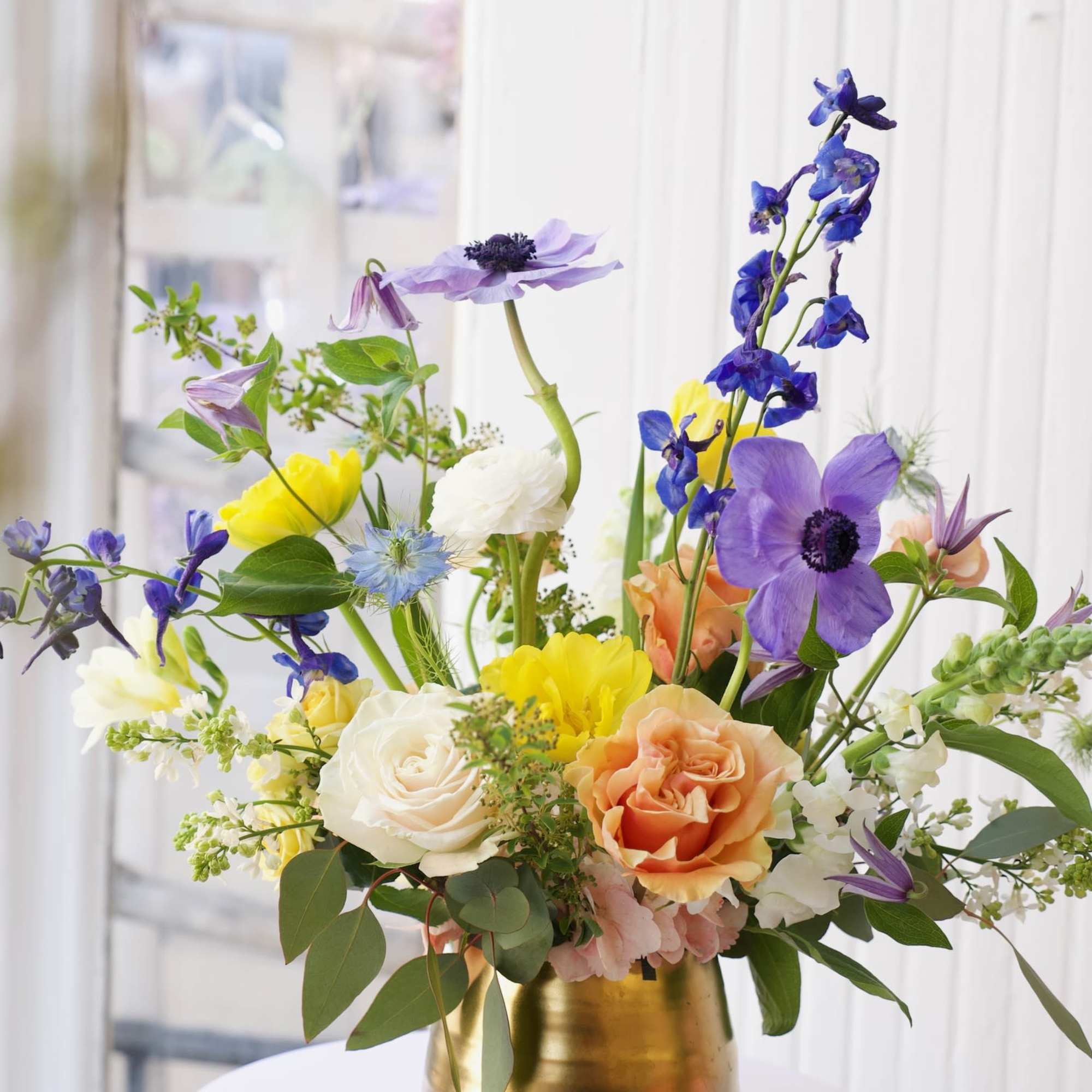 A dreamy blend of delphinium, anemones, roses, and ranunculus—soft hues and bright A dreamy blend of delphinium, anemones, roses, and ranunculus—soft hues and bright