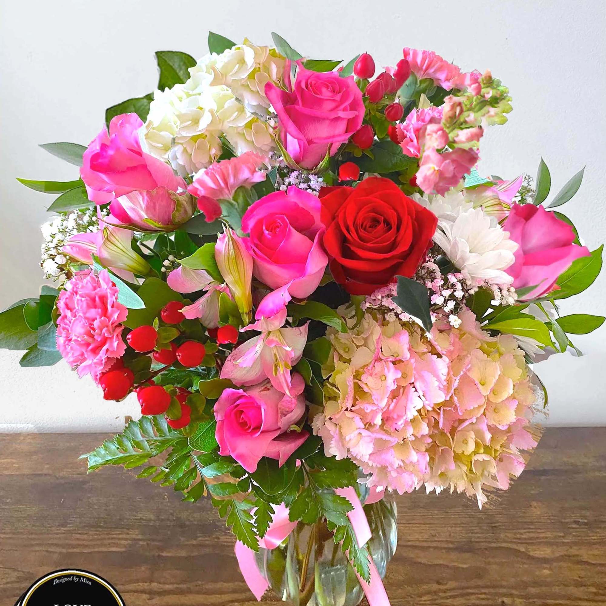 A lovely and bright arrangement designed in a glass vase made with