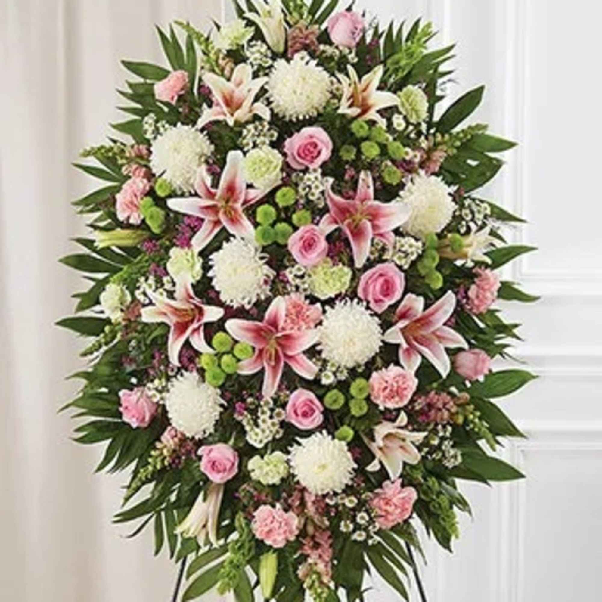 Send a sympathy floral standing spray created by a local florist, hand