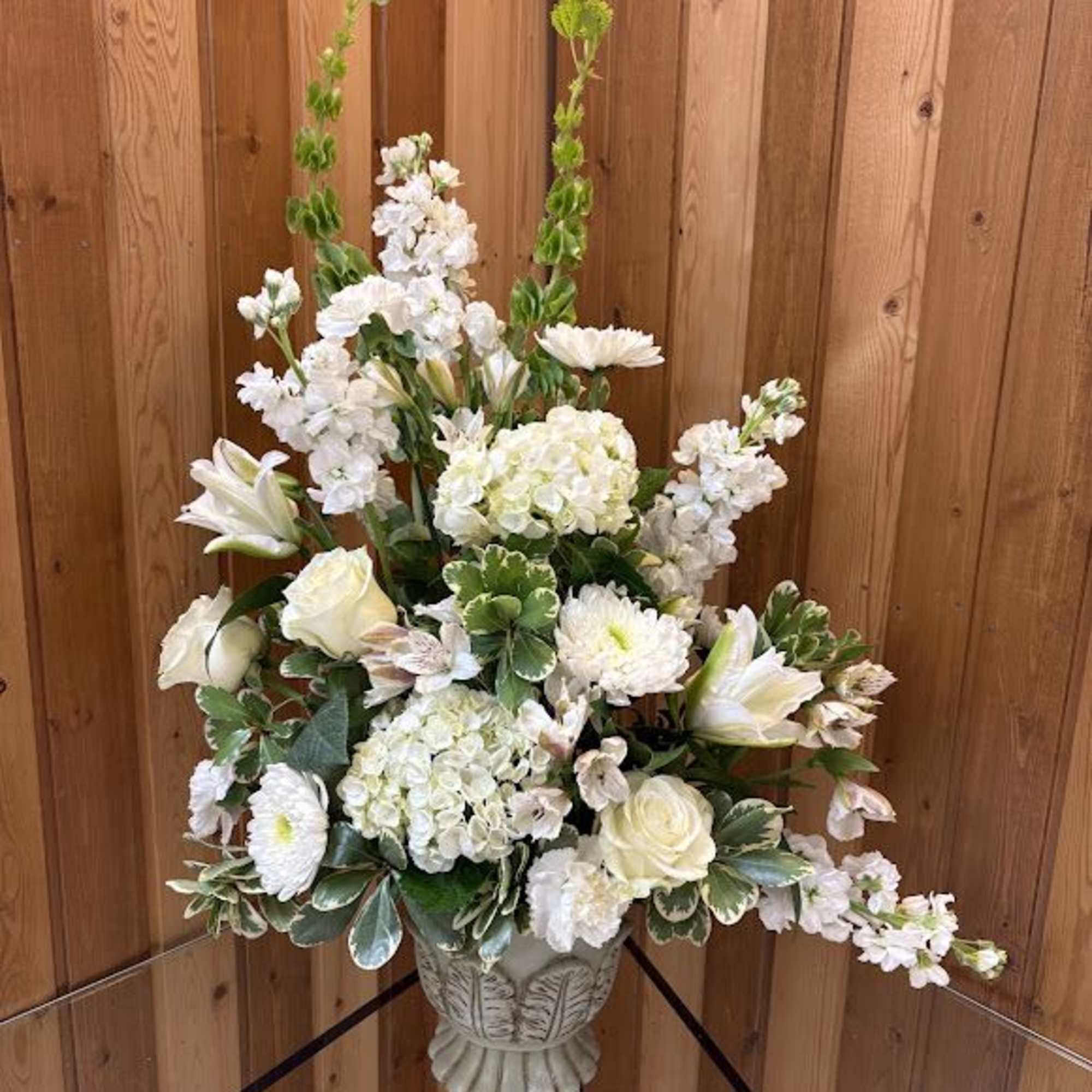 Stunning arrangement in a pedestal container featuring gorgeous white flowers of all Stunning arrangement in a pedestal container featuring gorgeous white flowers of all