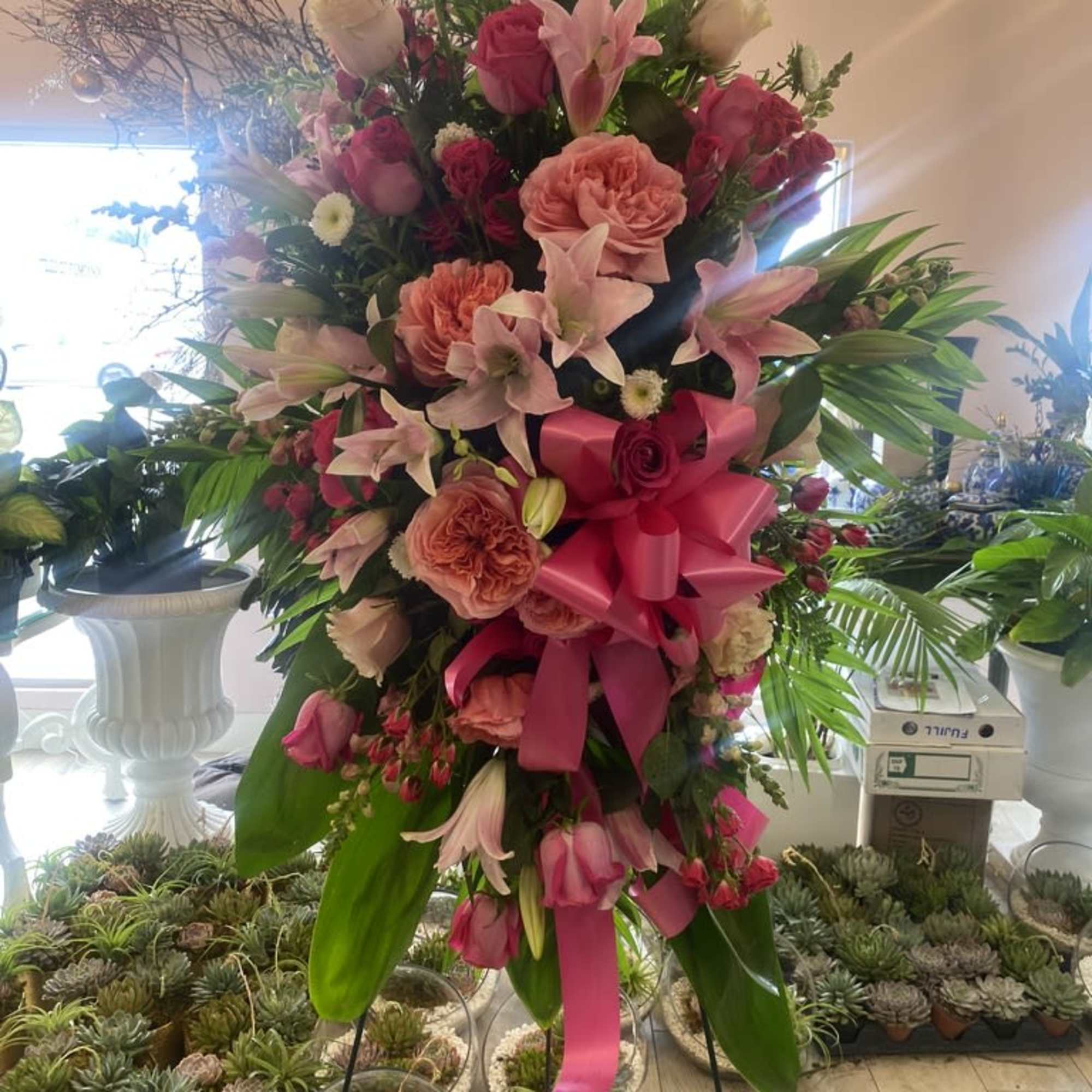 Soft, graceful, and full of tender beauty, our "Heavenly Embrace" standing spray