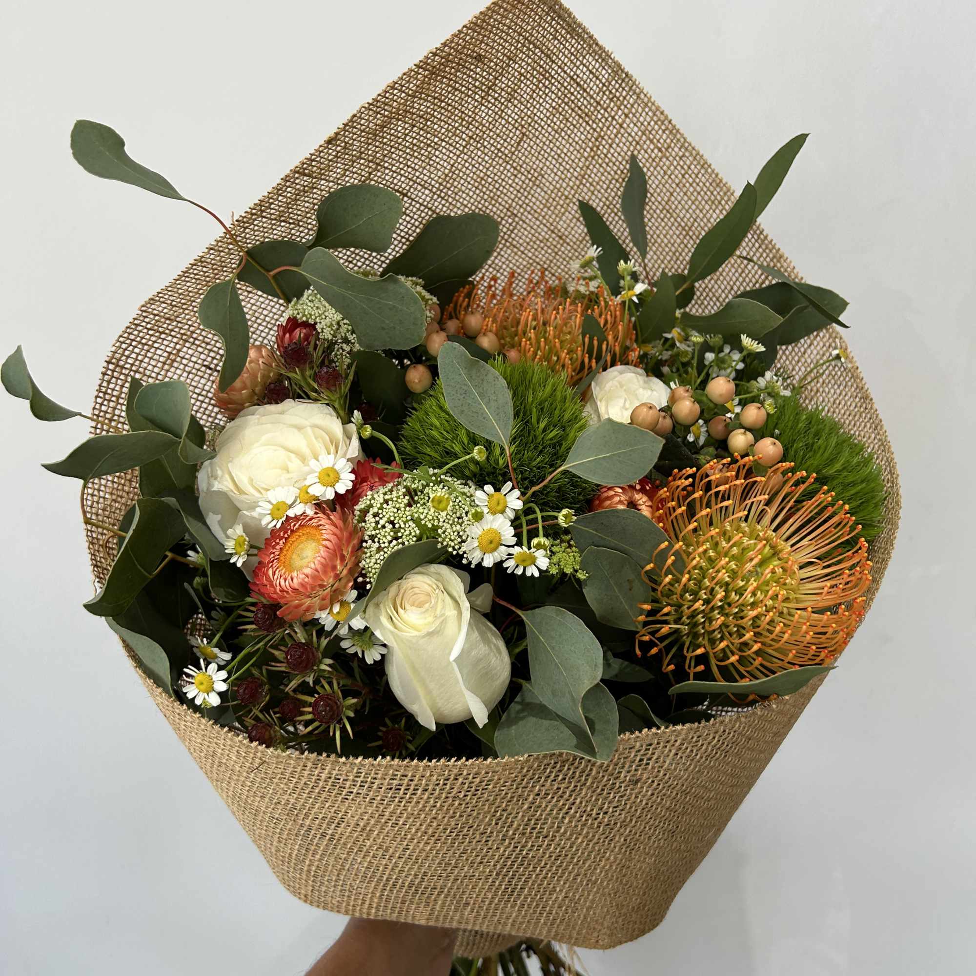 Seasonal flowers arranged into a rustic bouquet. 