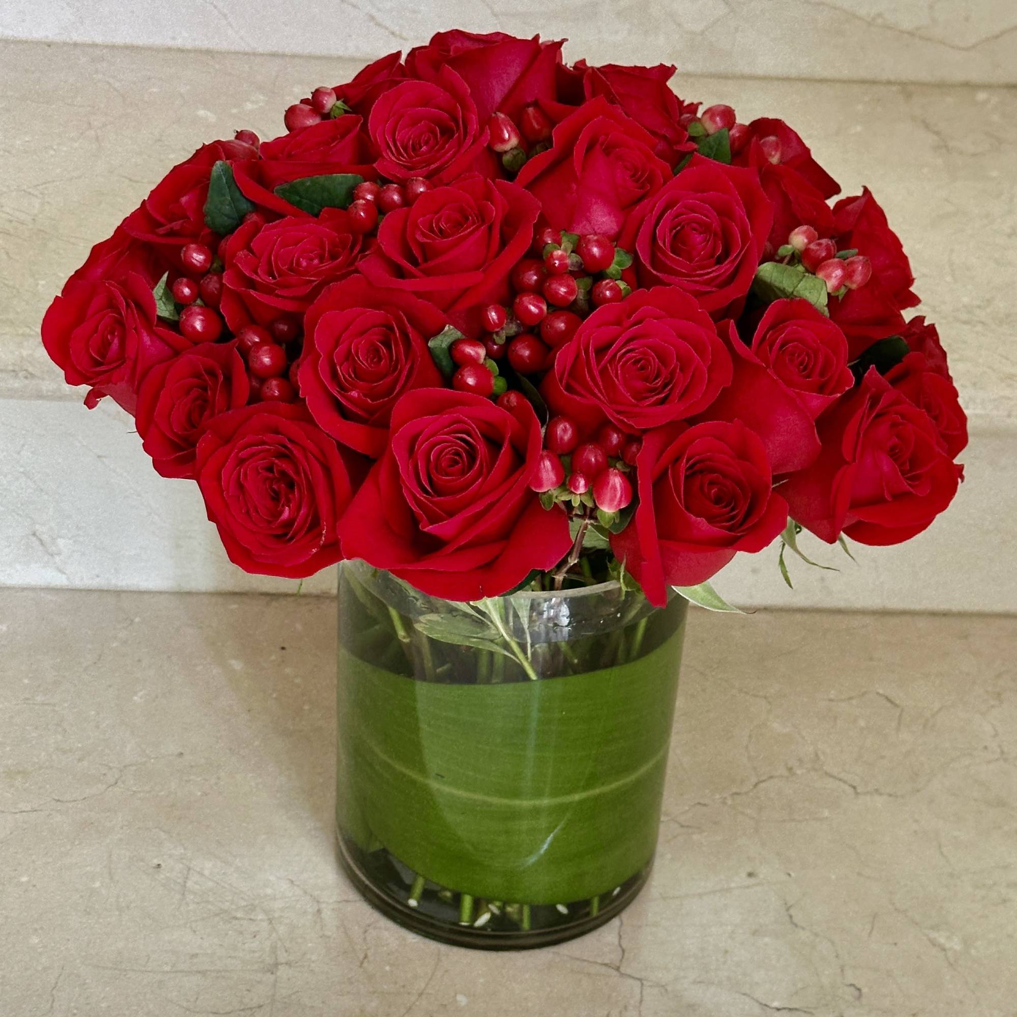 A stunning arrangement of 36 select red roses, artfully designed in a A stunning arrangement of 36 select red roses, artfully designed in a