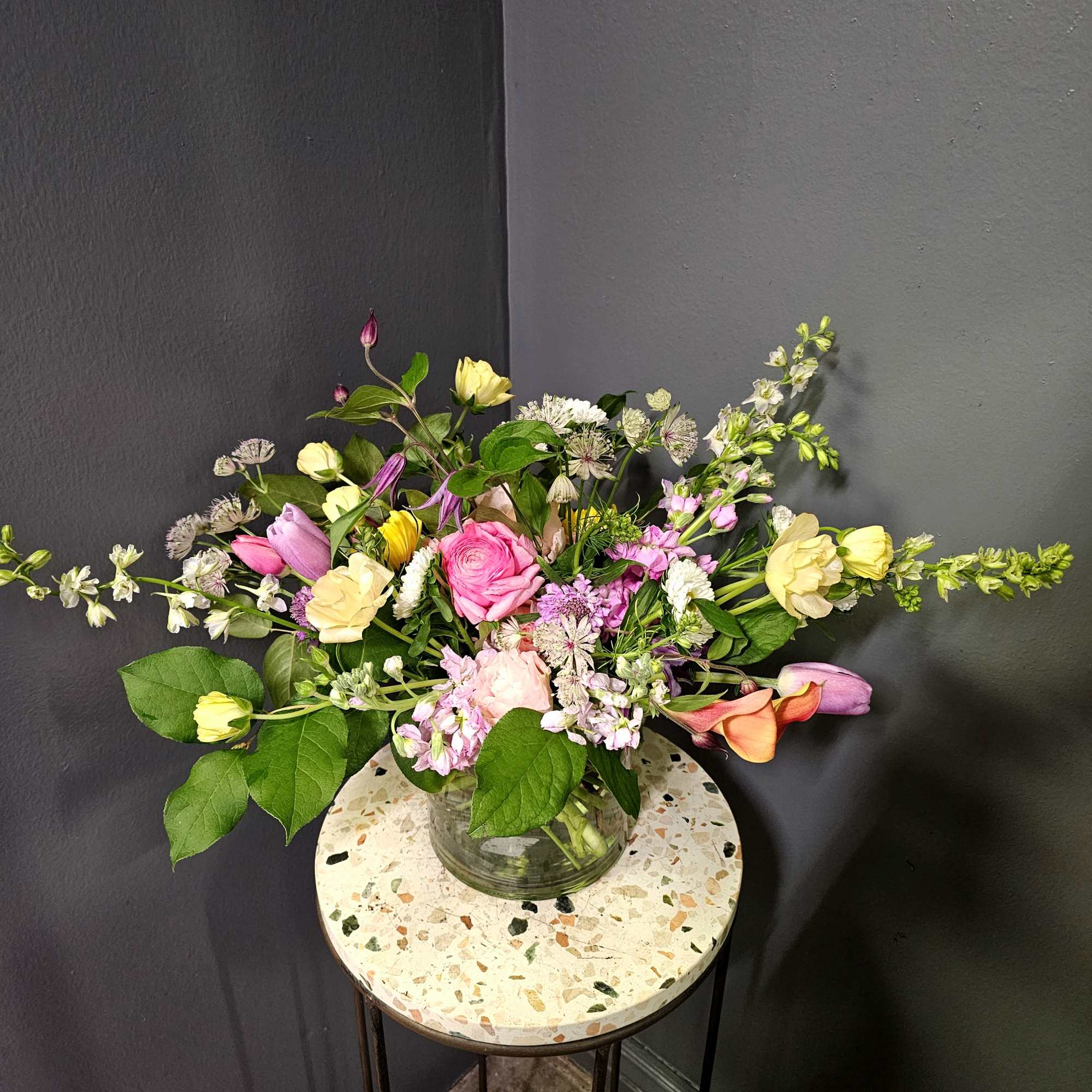 This exquisite spring flower arrangement bursts with luxurious, textural beauty, perfect for