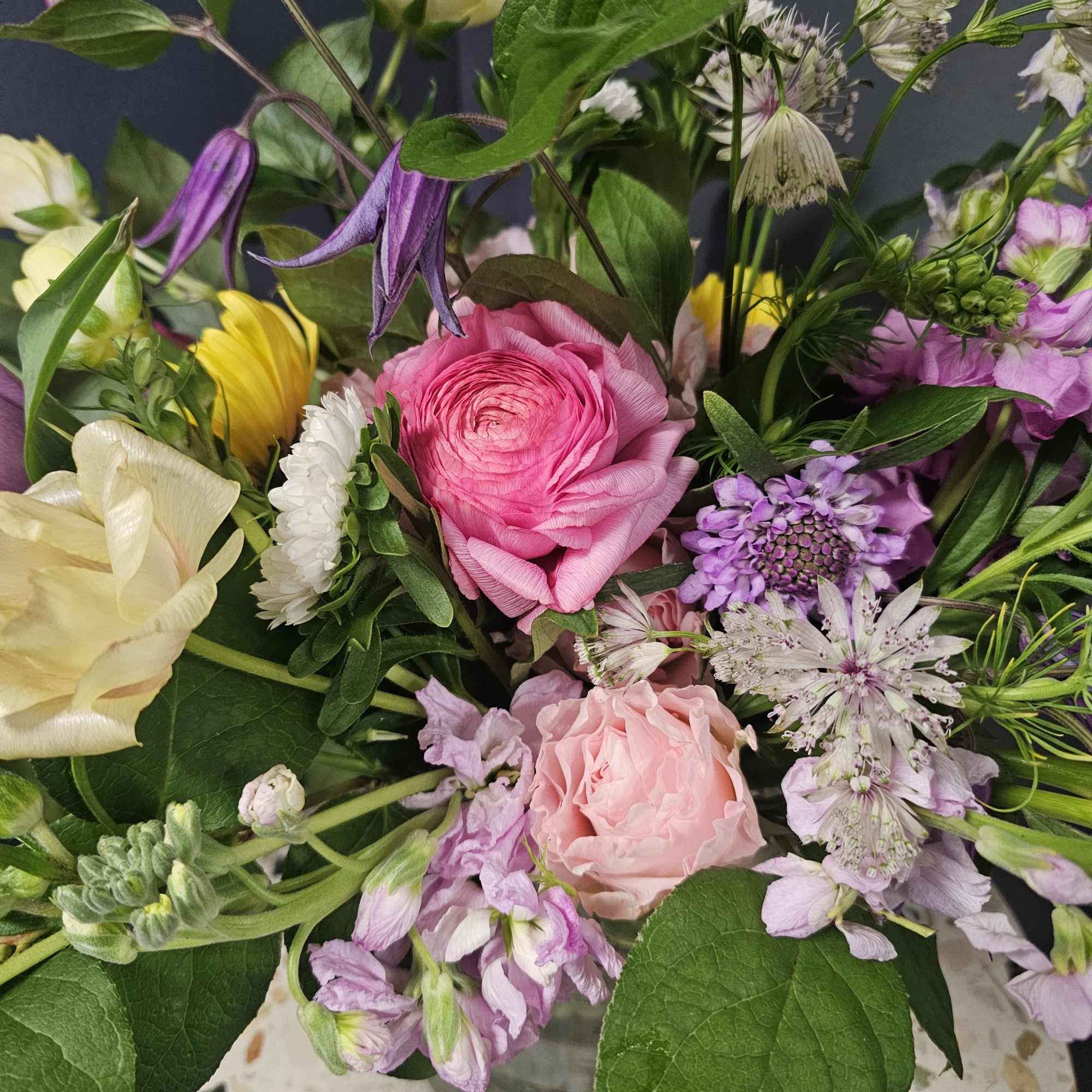 This exquisite spring flower arrangement bursts with luxurious, textural beauty, perfect for