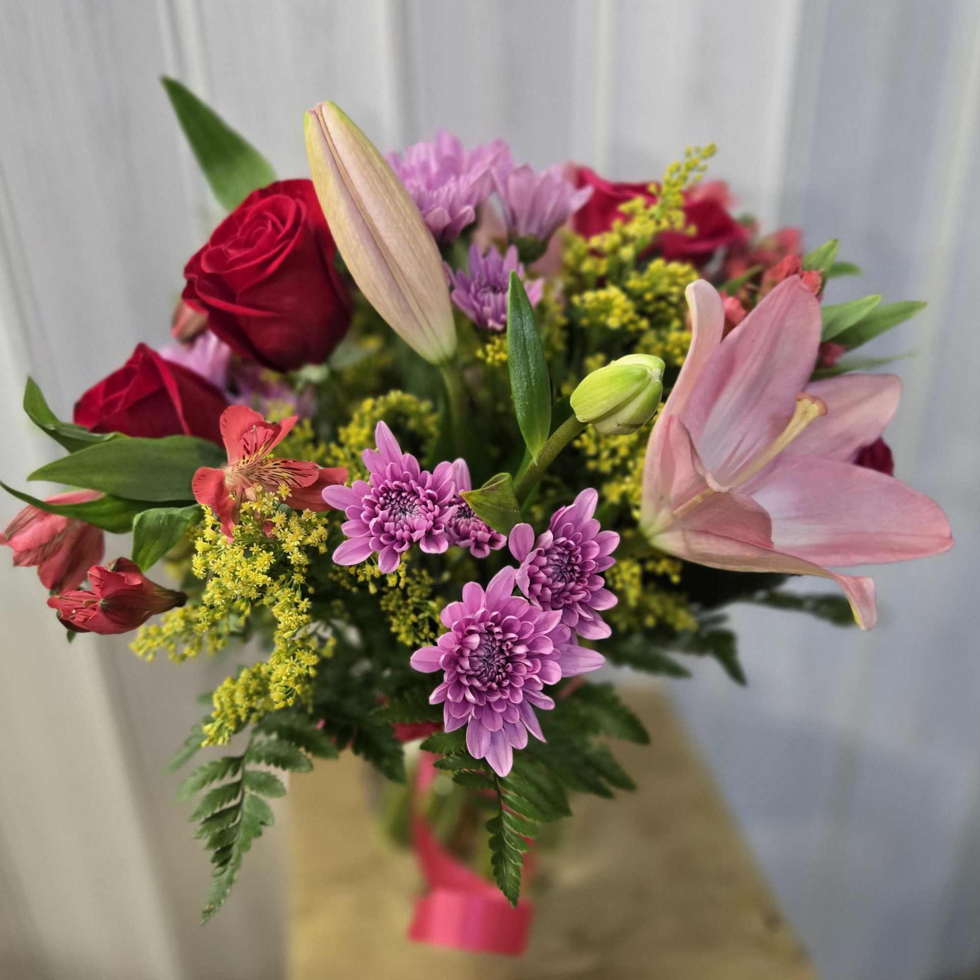 This is a lovely, romantic yet cheerful floral arrangement with a soft