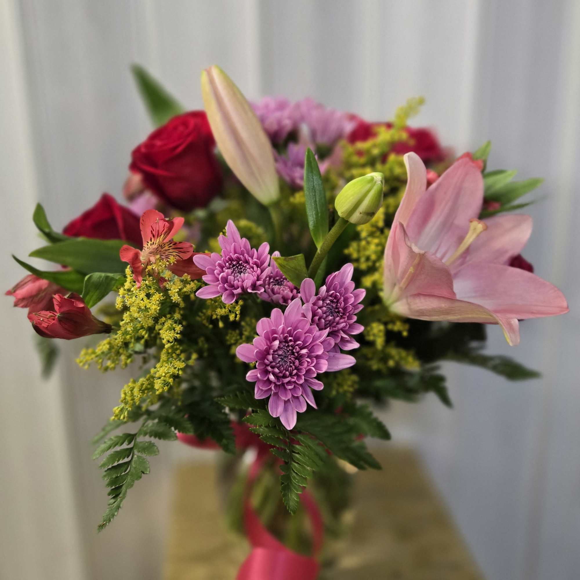 This is a lovely, romantic yet cheerful floral arrangement with a soft