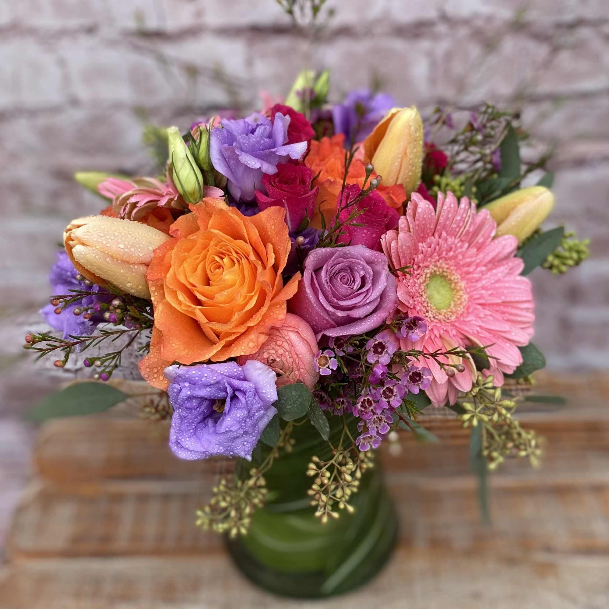An assortment of Roses, Gerbera Daisies, Tulips, and Lilies in a vase. An assortment of Roses, Gerbera Daisies, Tulips, and Lilies in a vase.
