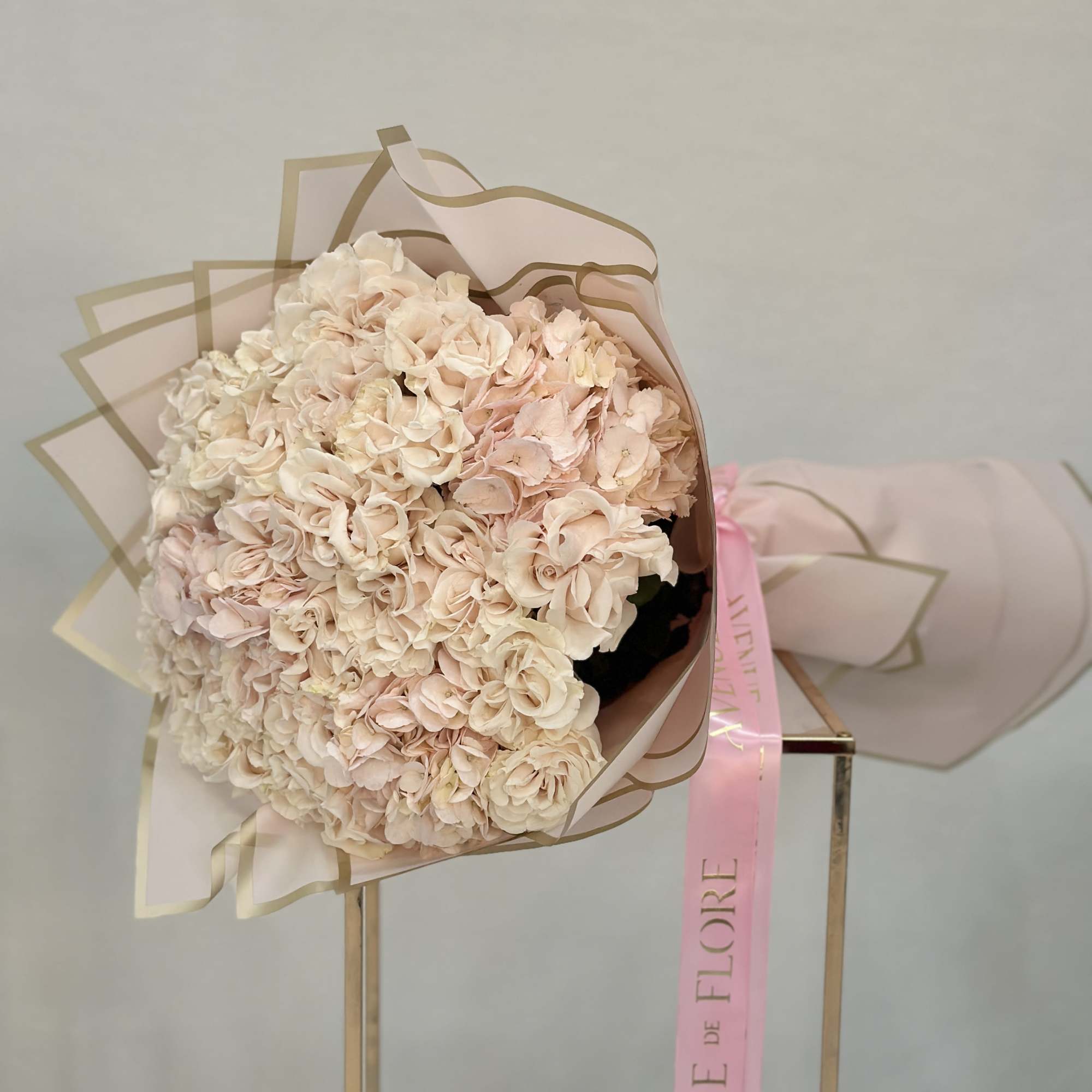 Featuring lush garden roses nestled among fluffy hydrangeas, this bouquet is a