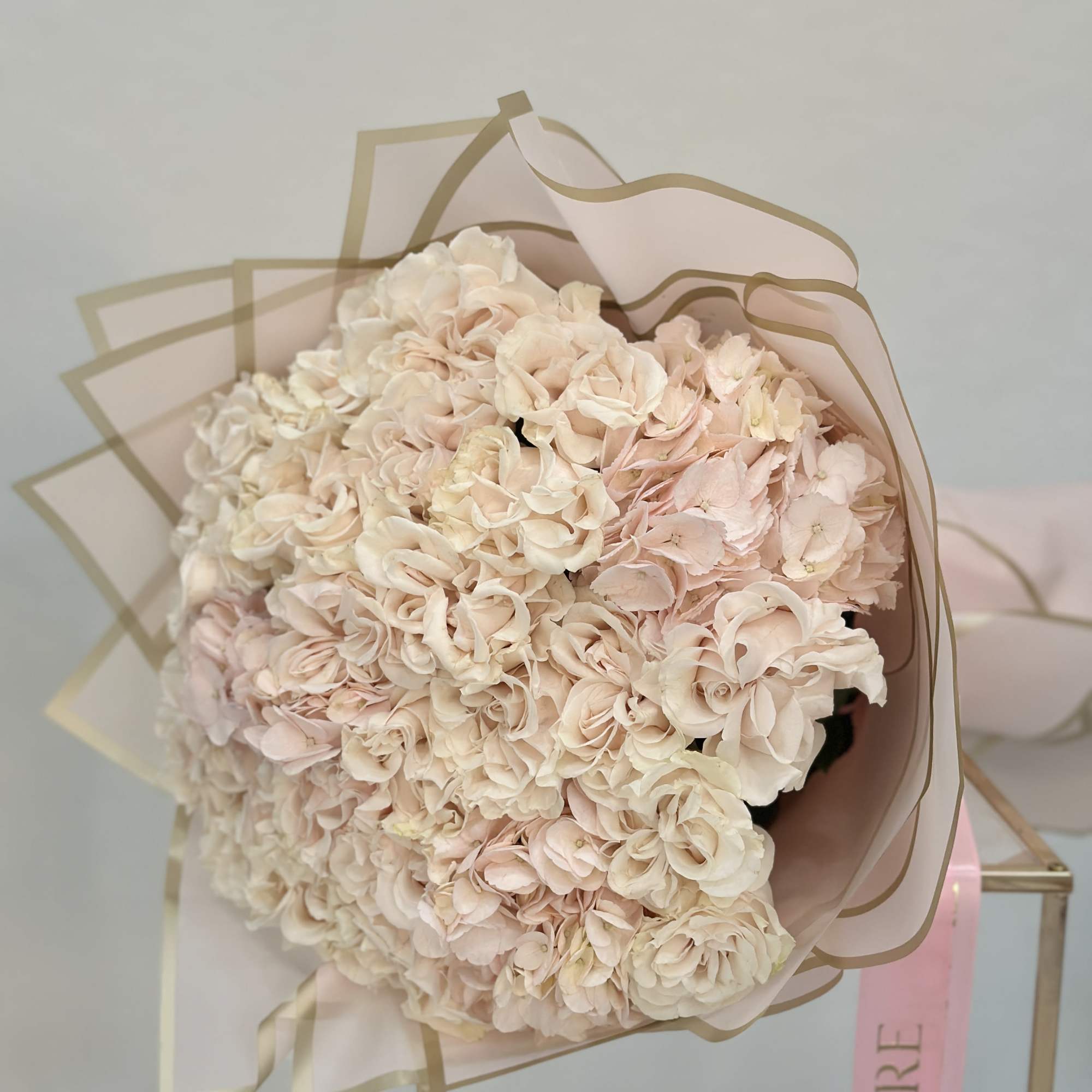 Featuring lush garden roses nestled among fluffy hydrangeas, this bouquet is a