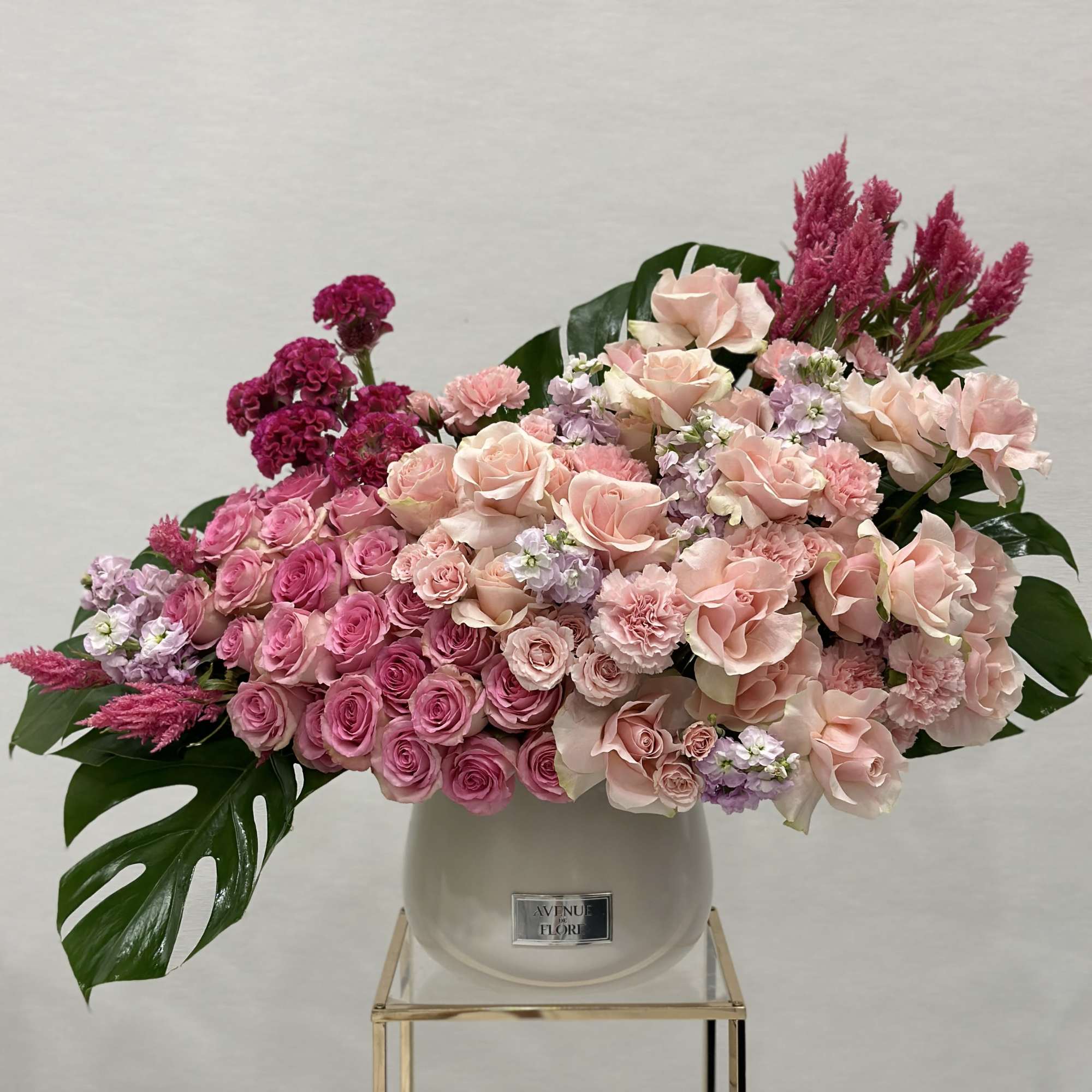 This luxurious arrangement features the timeless beauty of soft pink roses, paired