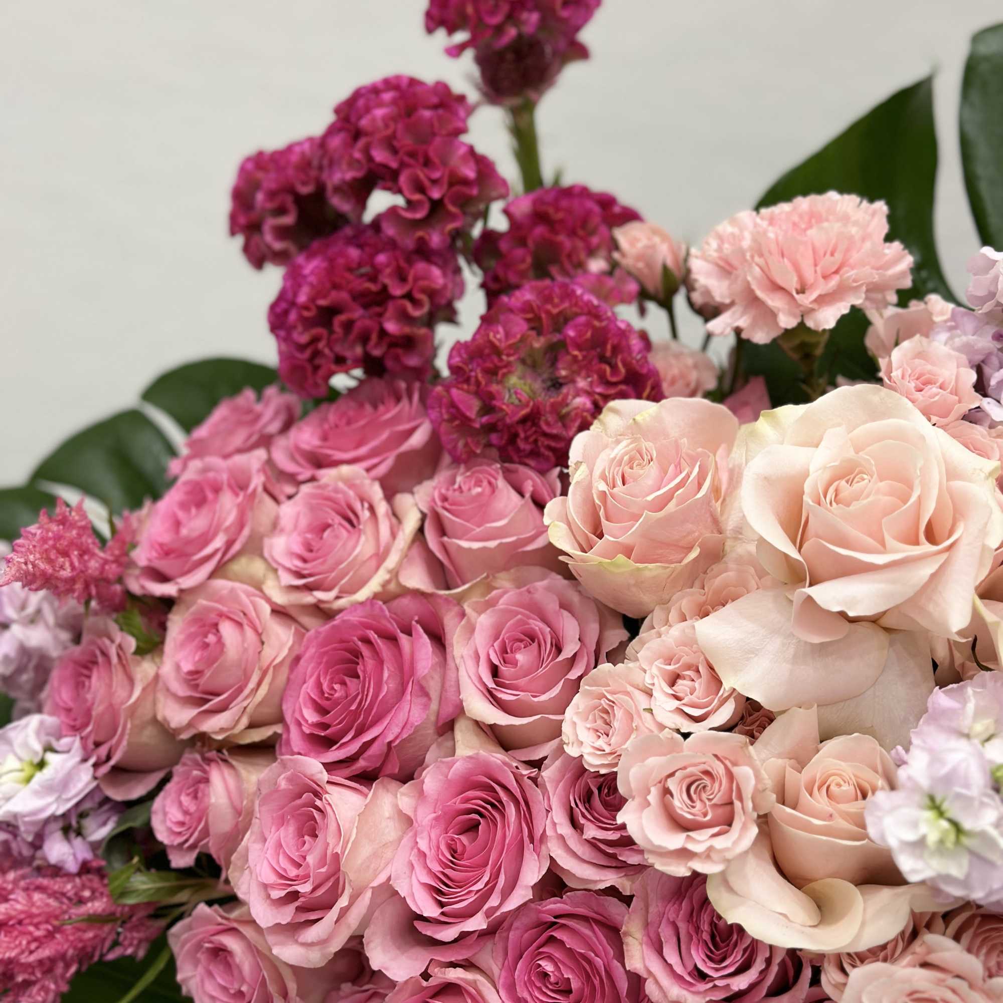 This luxurious arrangement features the timeless beauty of soft pink roses, paired