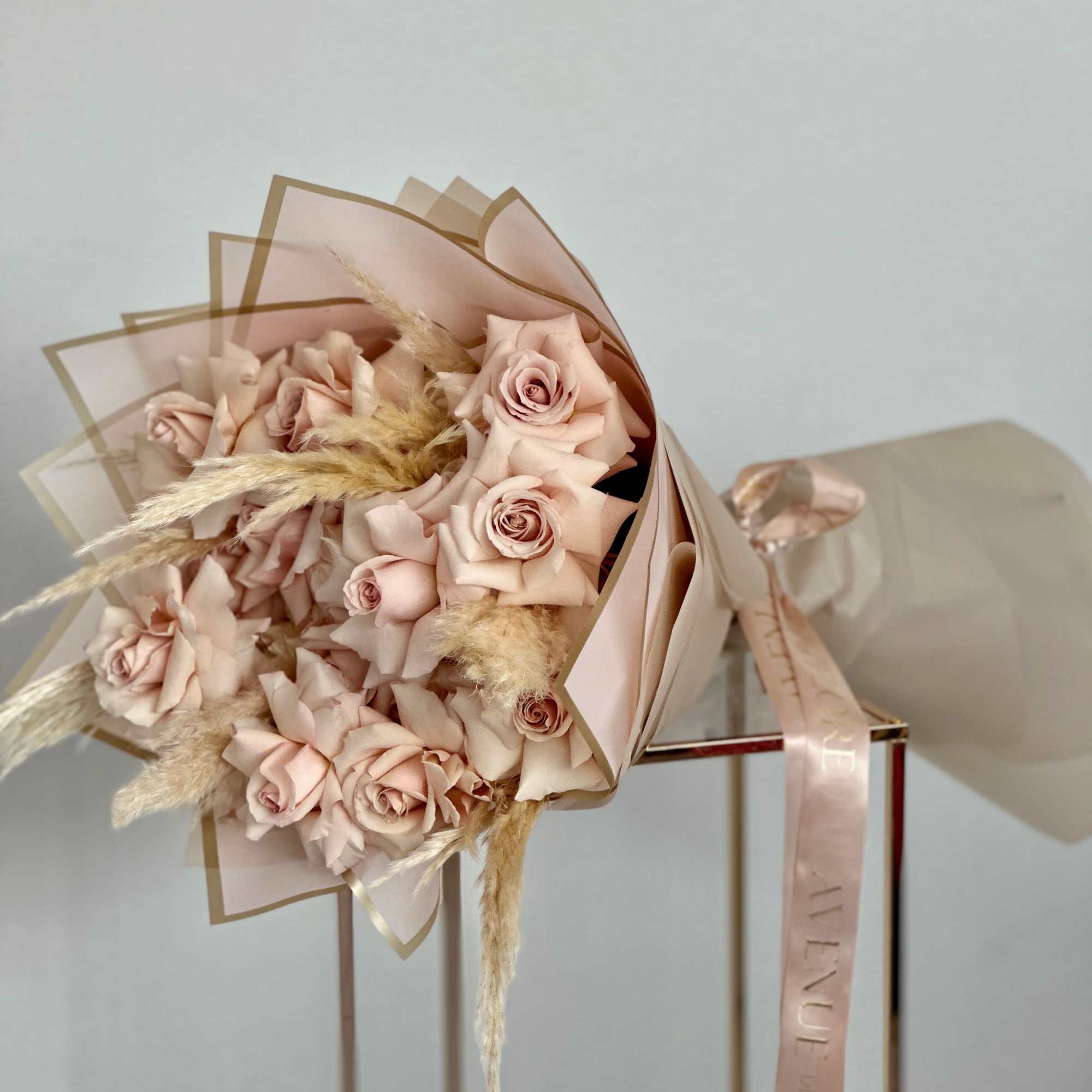 This bouquet features a mesmerizing array of soft beige roses, each one