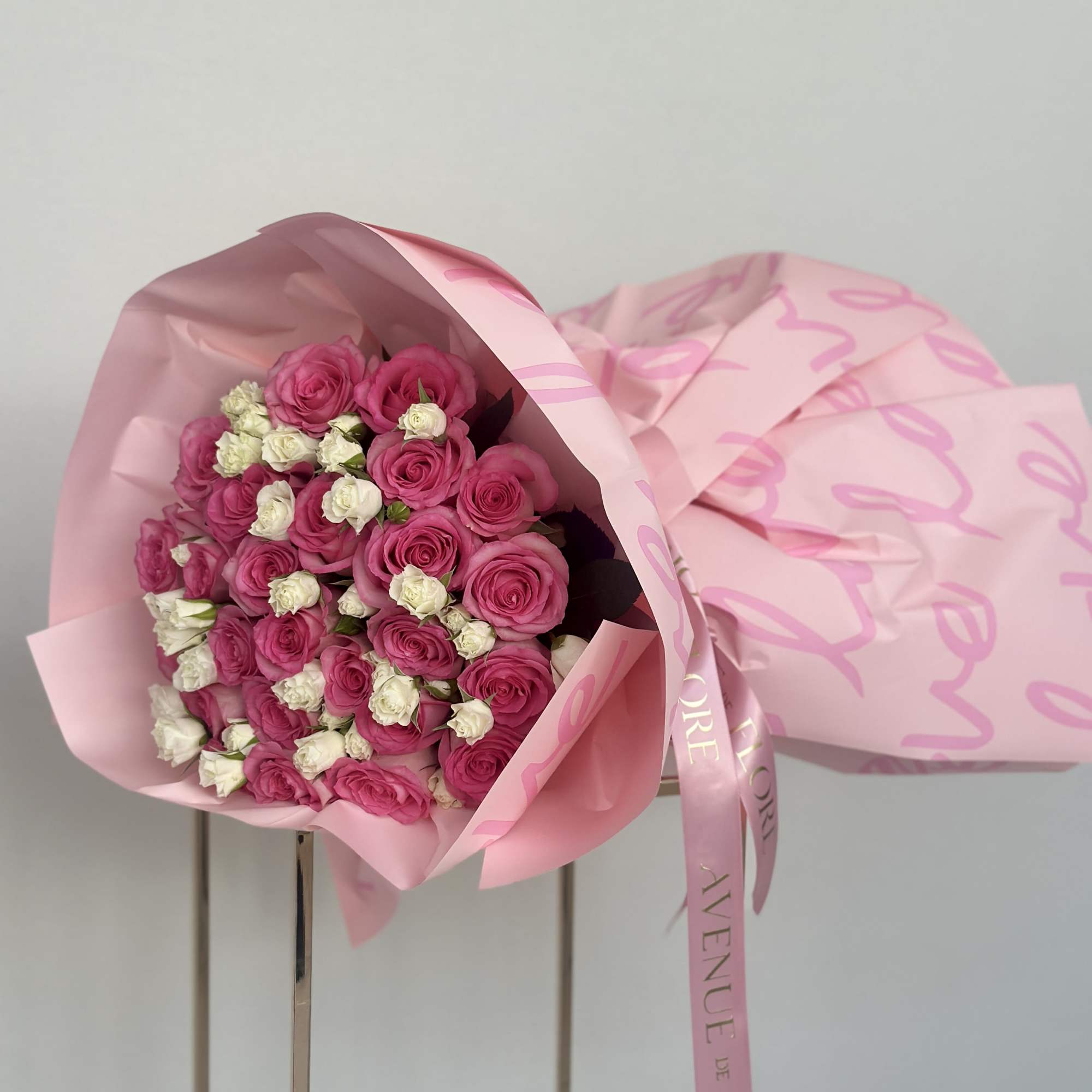 This beautiful bouquet of pink roses and white spray roses is a