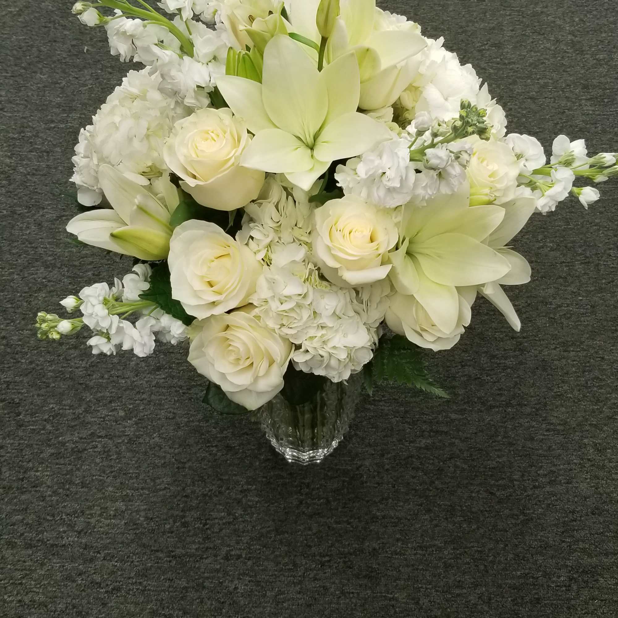 This arrangement is designed in a heavy luxury faceted vase.  It