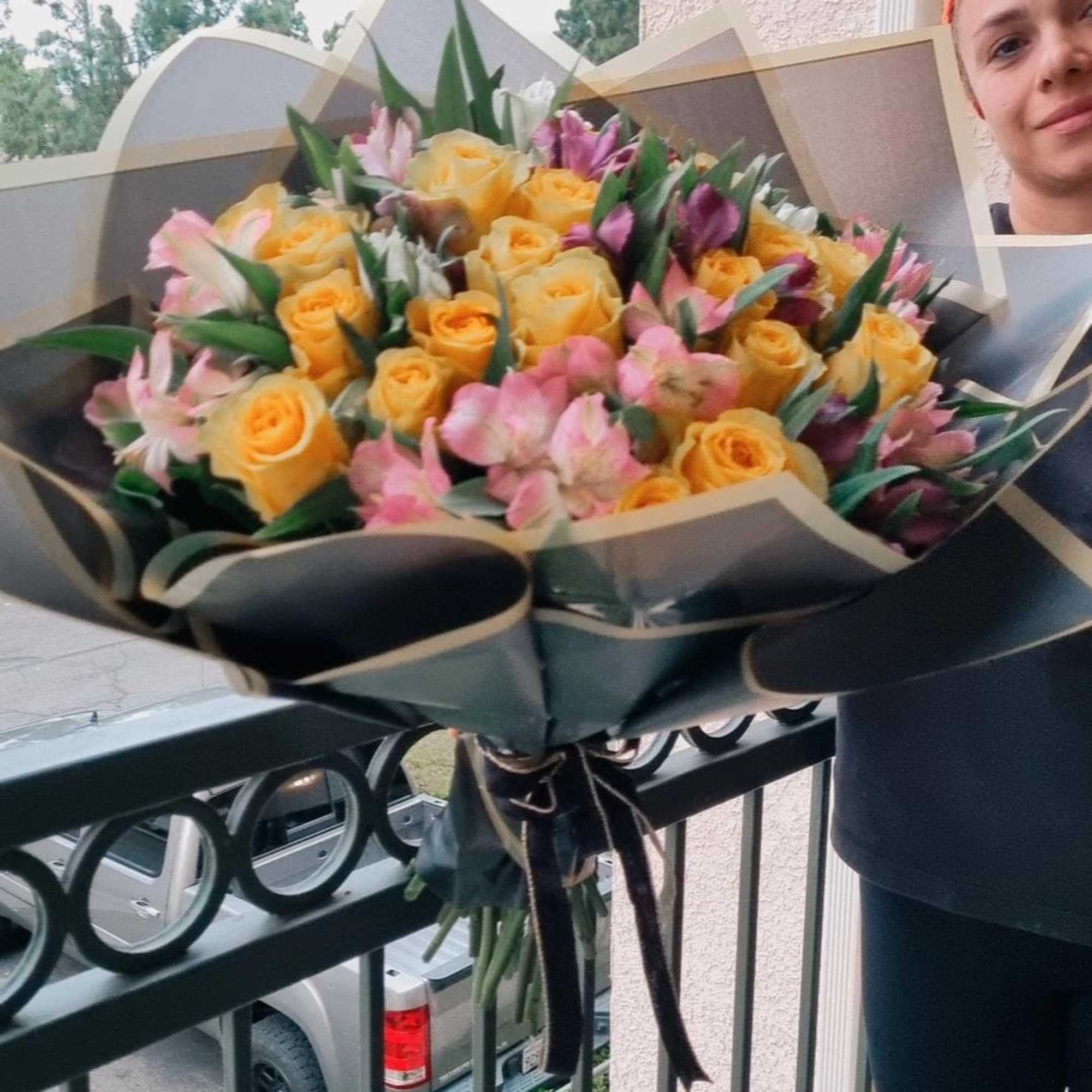  a stunning bouquet of vibrant yellow roses mixed with delicate pink