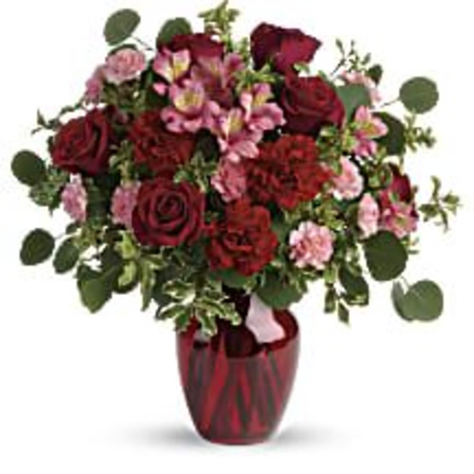 
The belle of the ball! Arranged in a ruby red vase, this