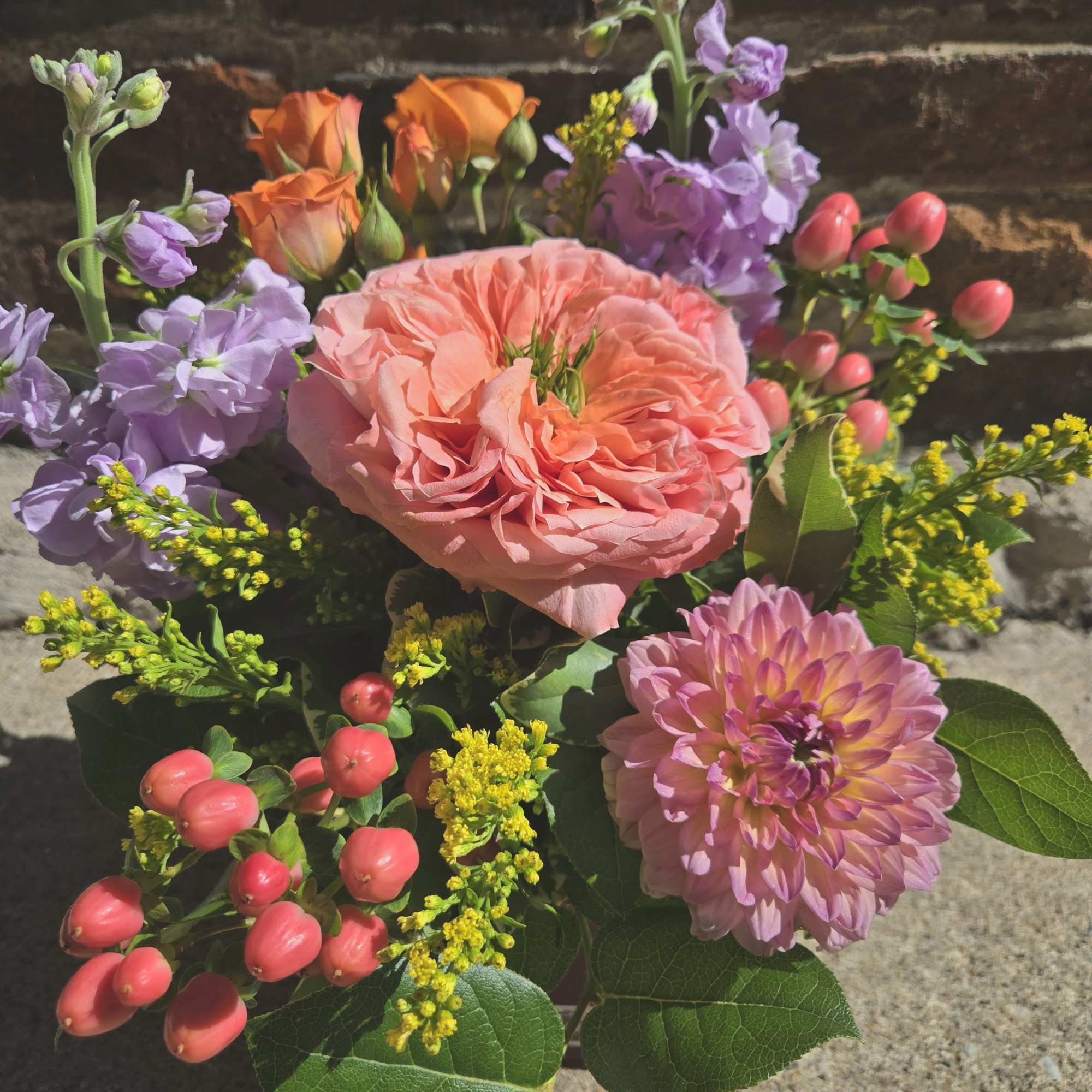 Pearlescence is a captivating arrangement designed in the colors of peach, pink Pearlescence is a captivating arrangement designed in the colors of peach, pink