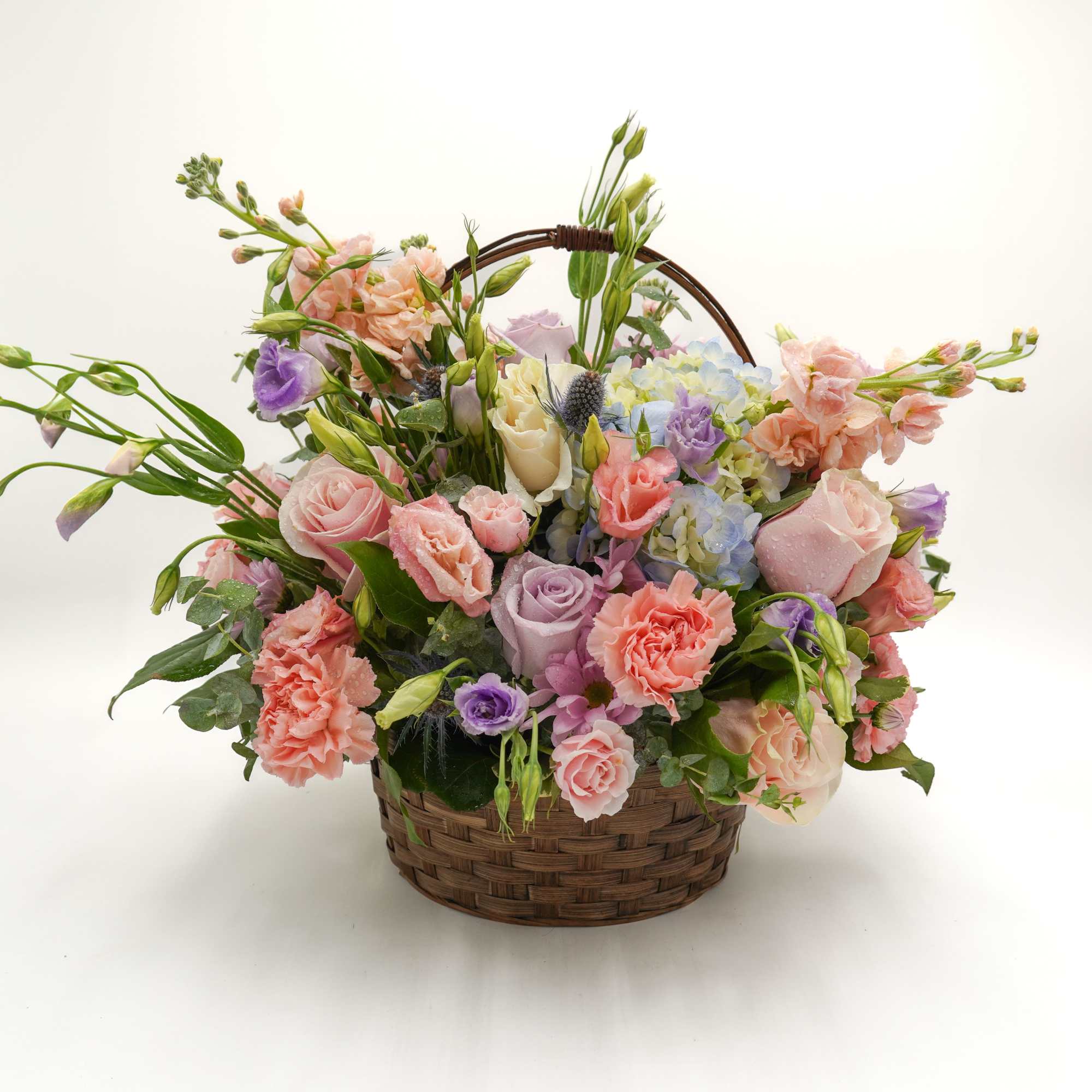 A lush mix of lavender and pink roses, spray roses, stock, and A lush mix of lavender and pink roses, spray roses, stock, and