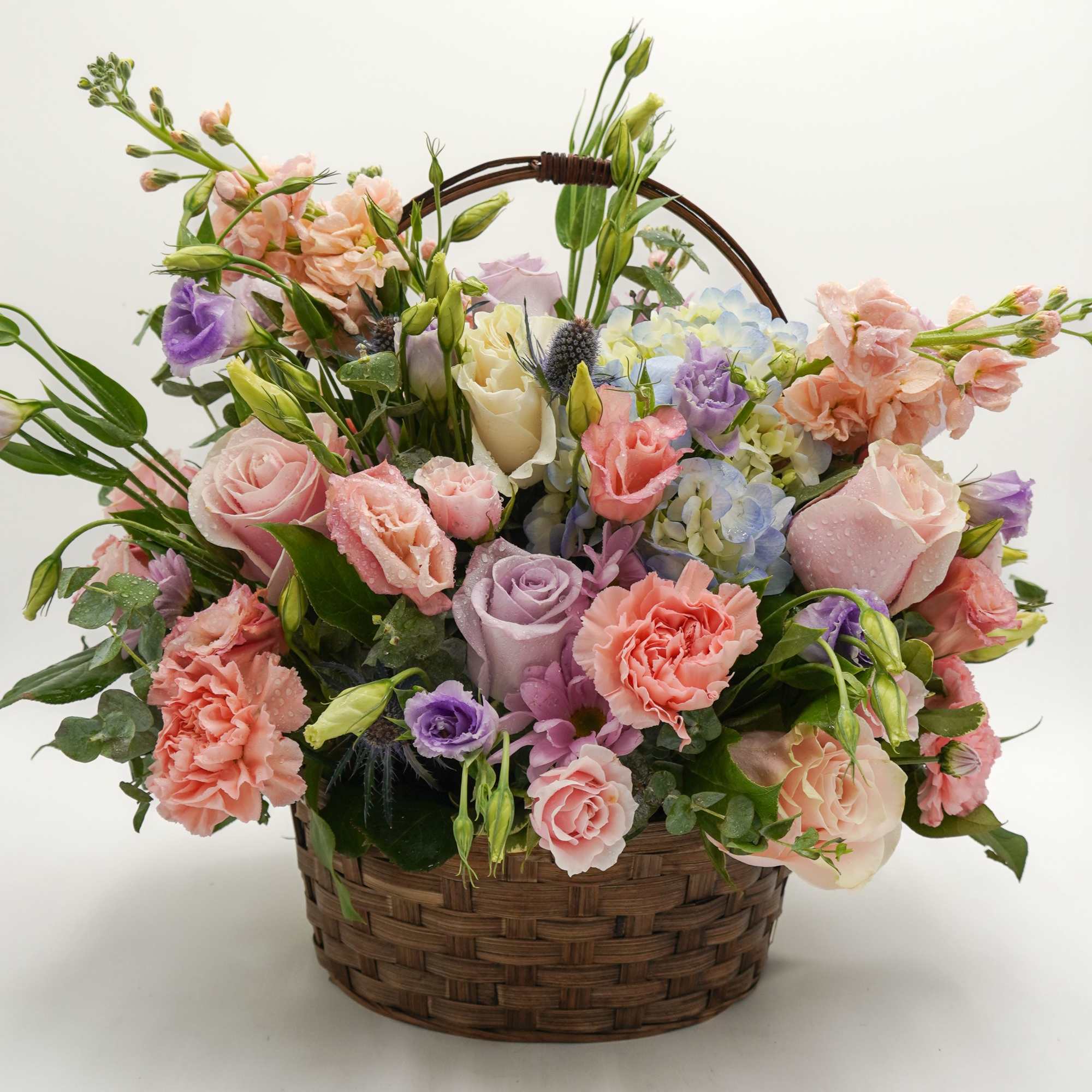 A lush mix of lavender and pink roses, spray roses, stock, and A lush mix of lavender and pink roses, spray roses, stock, and