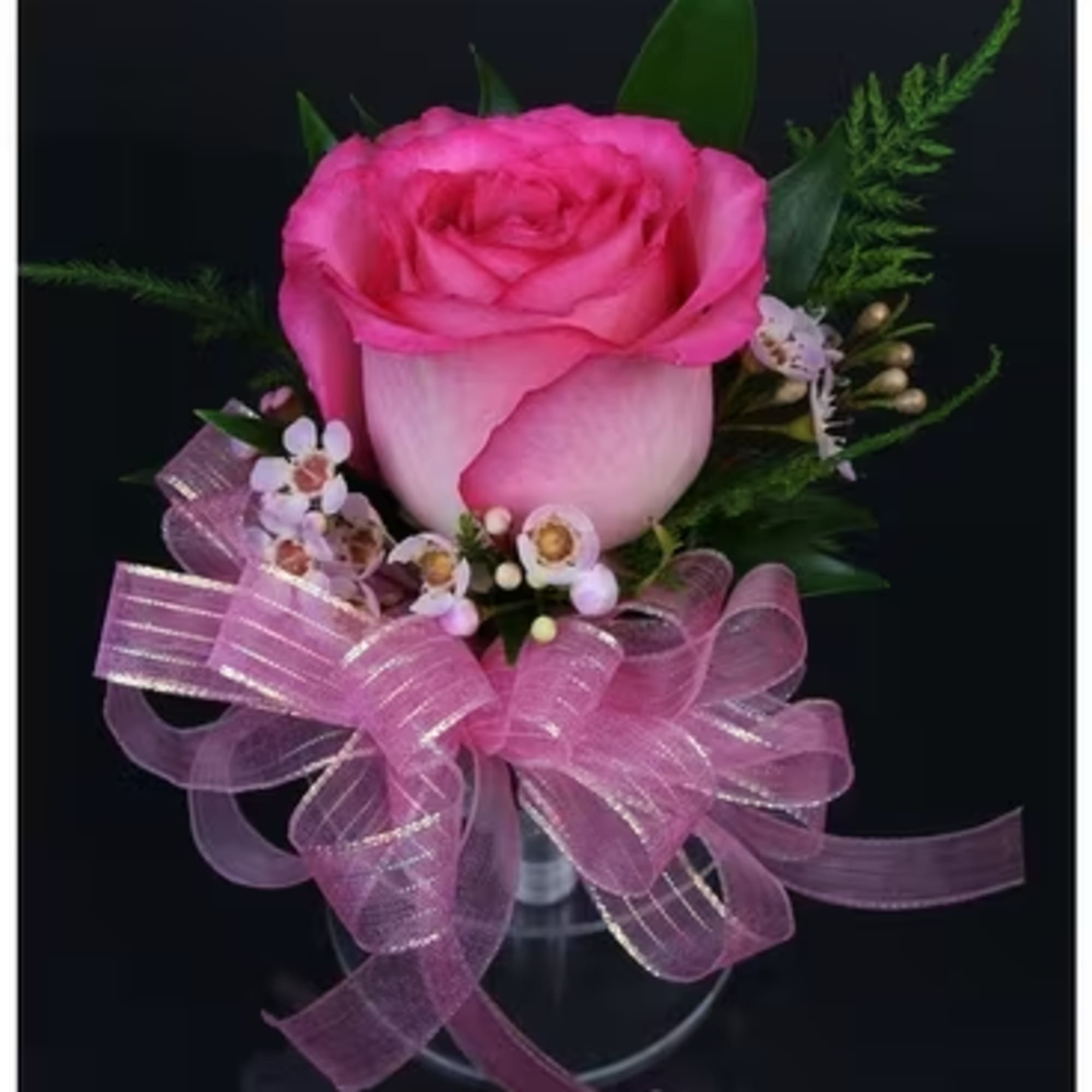 A pink corsage is a delicate floral accessory that radiates charm and A pink corsage is a delicate floral accessory that radiates charm and