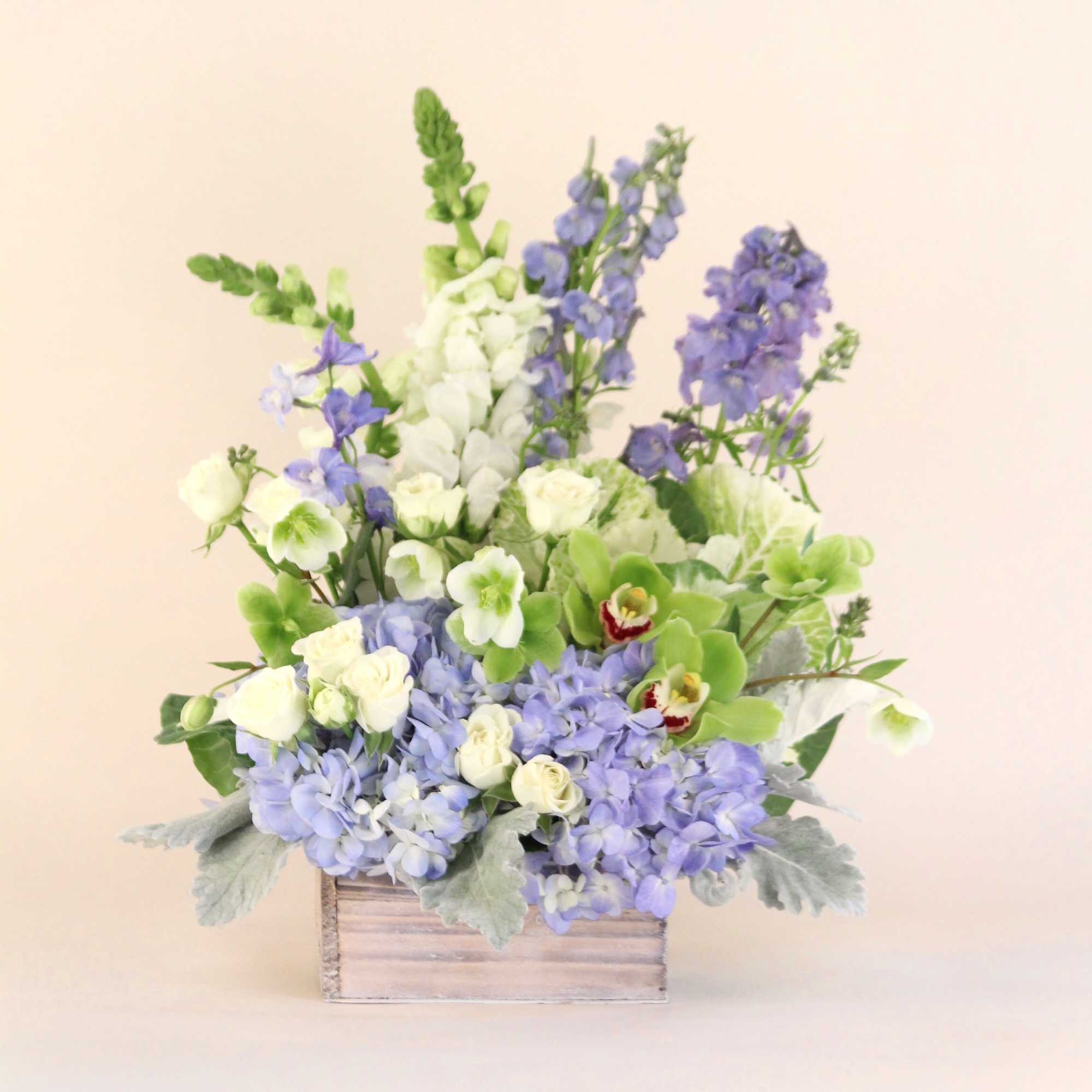A lush arrangement of blues and whites in a white wash wooden