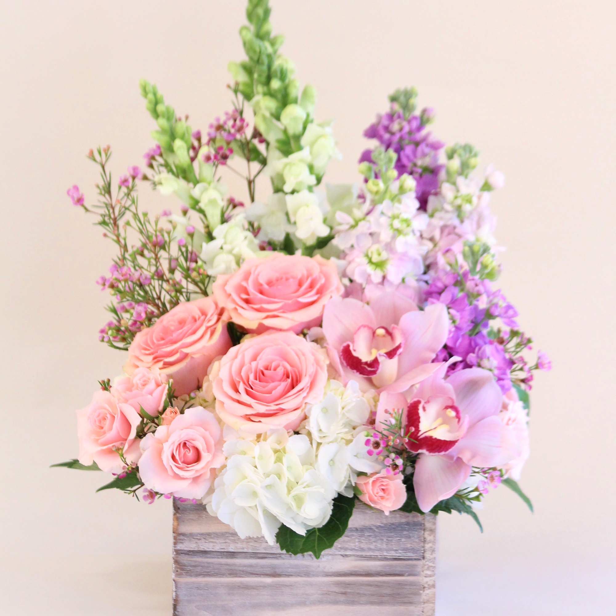 Different shades of pinks and lavender in a rustic wooden box. A