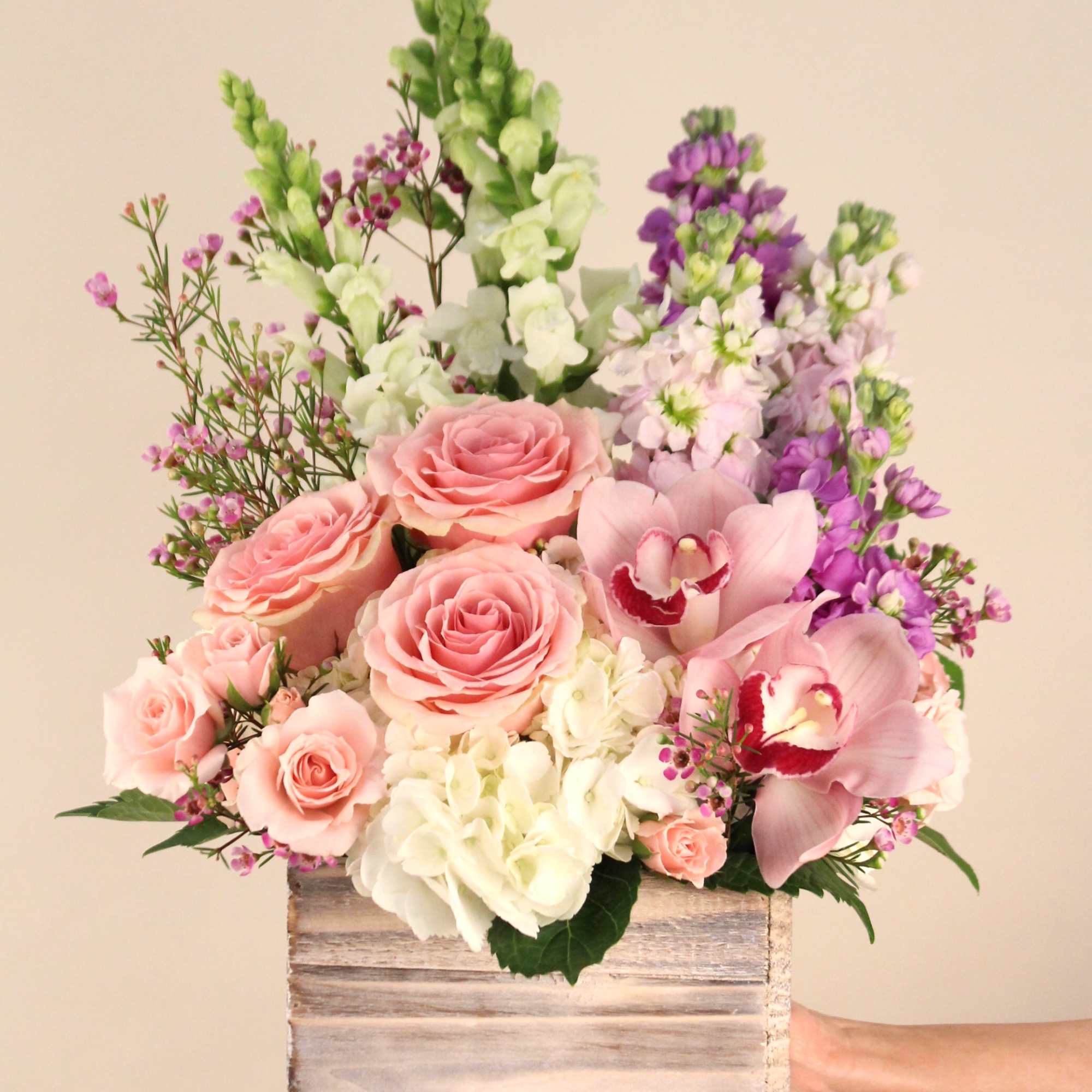 Different shades of pinks and lavender in a rustic wooden box. A