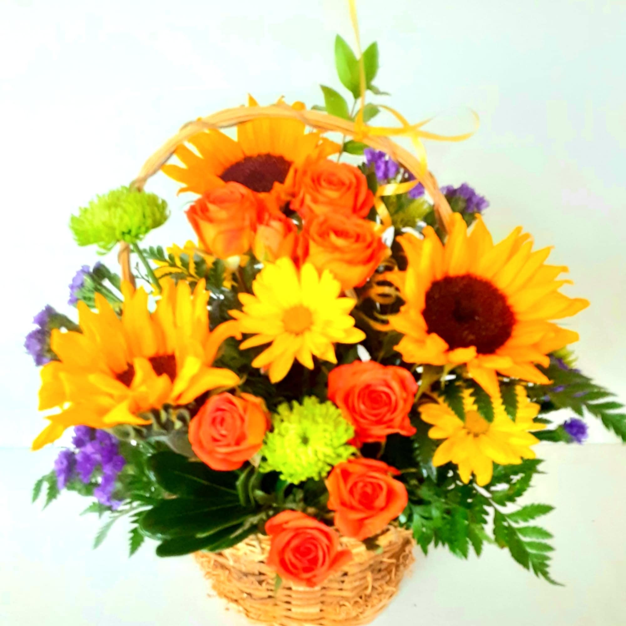A basket of beautiful sunflowers,orange spray roses,bright yellow daisies and more.Just the