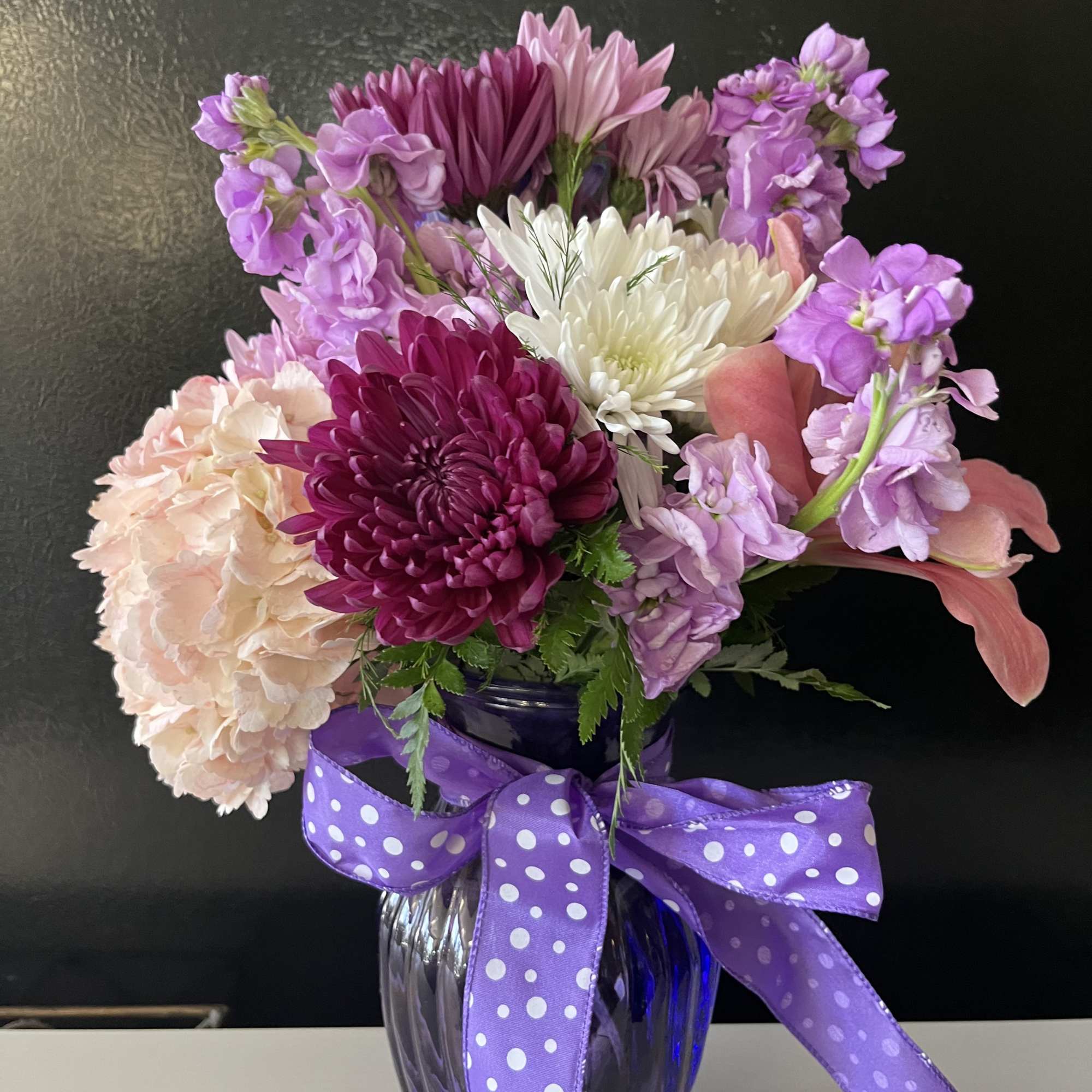 Fresh flowers in purple vase 