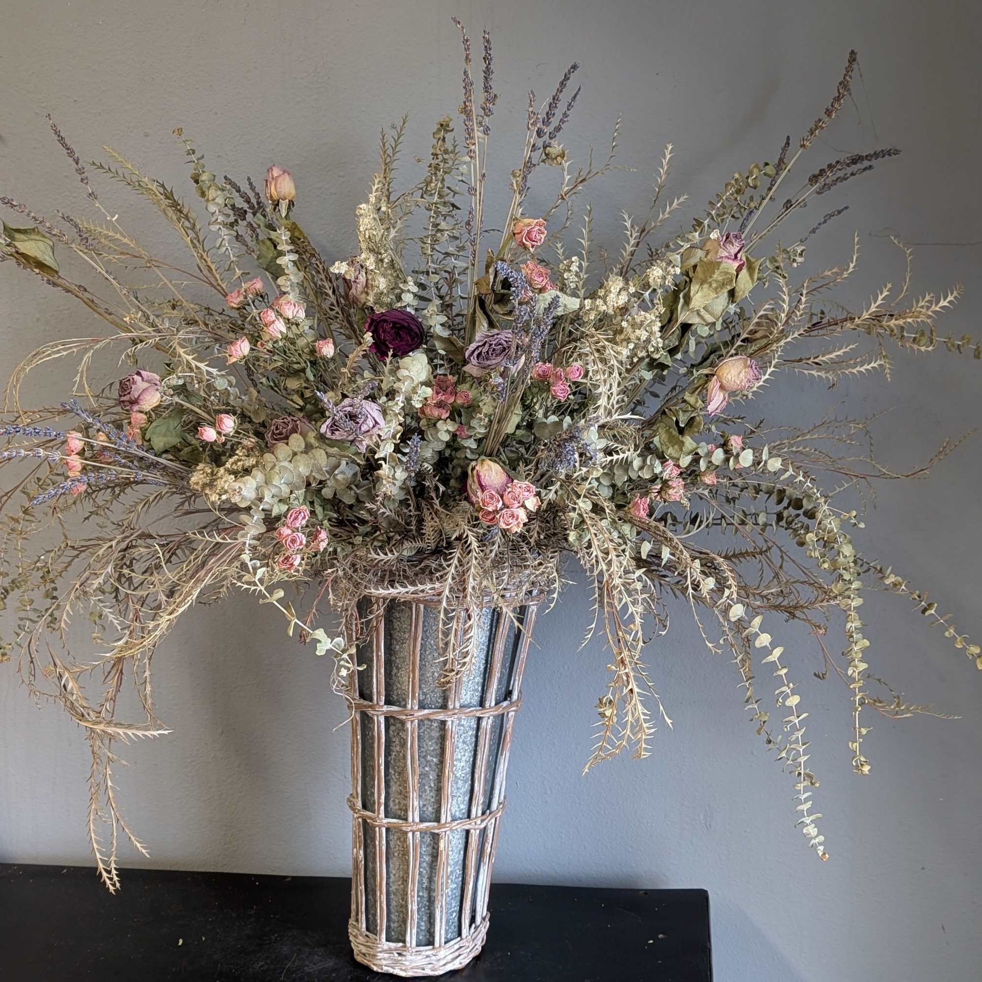 A beautiful DRIED arrangement of softer pinks and neutral colors in a