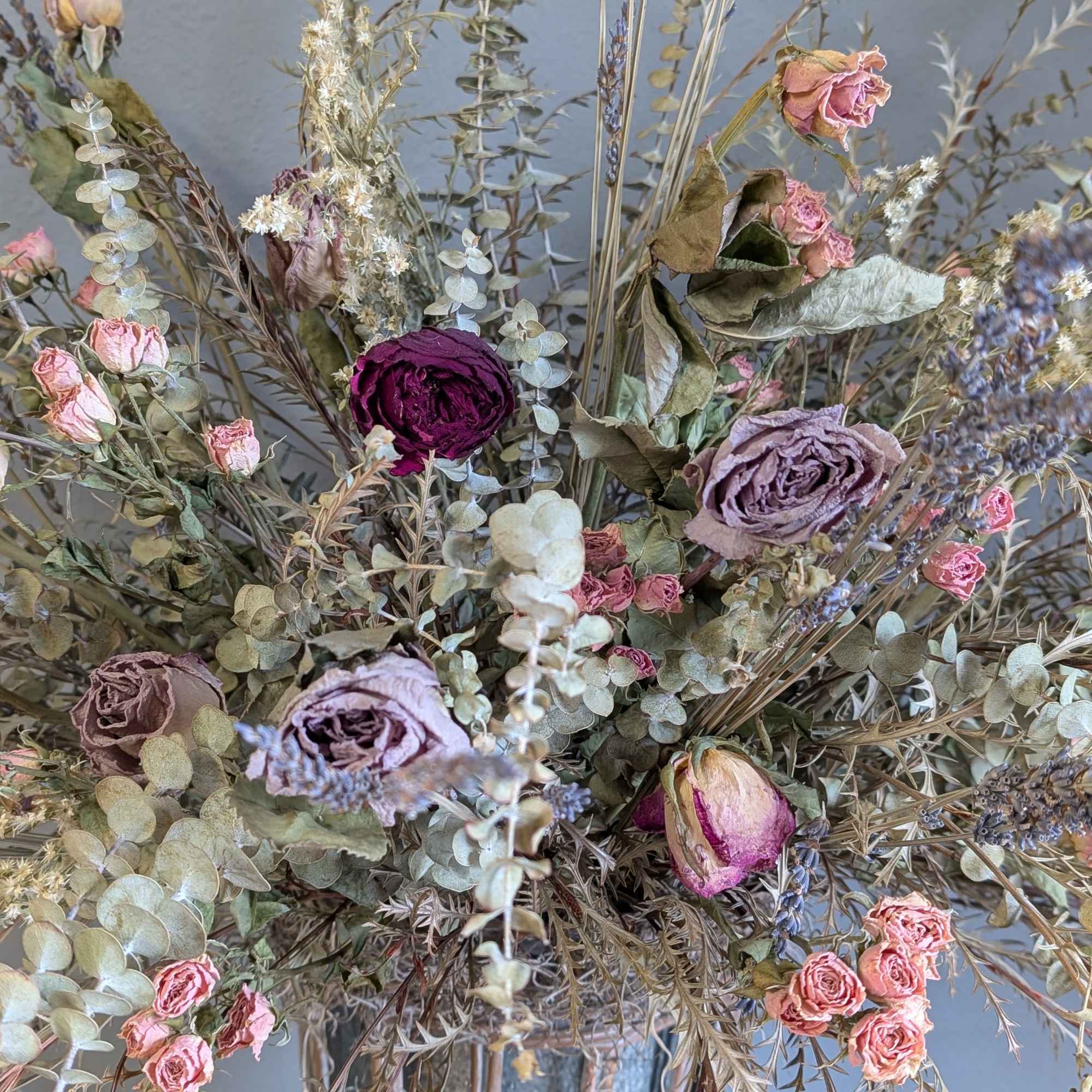A beautiful DRIED arrangement of softer pinks and neutral colors in a