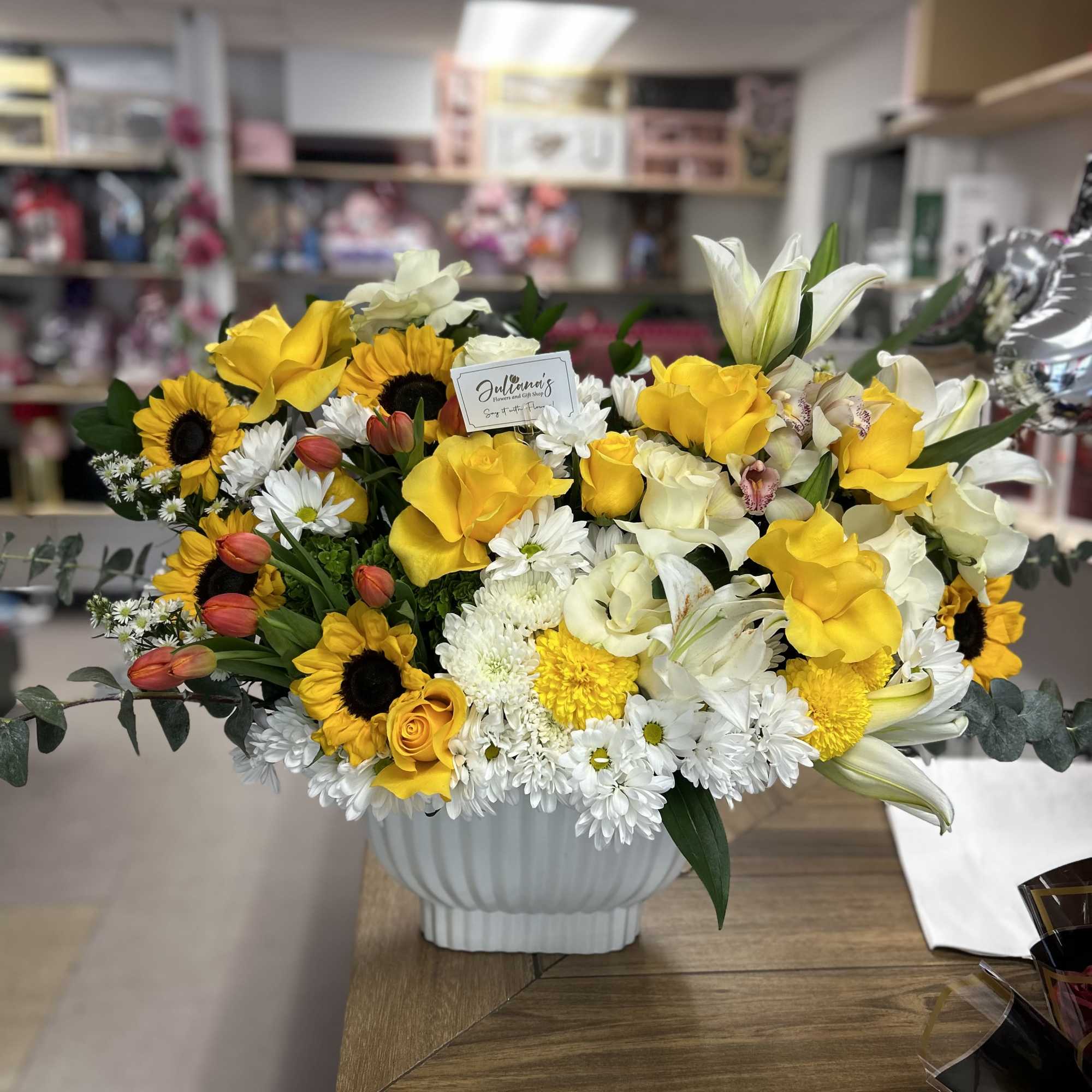Modern floral arrangement in base! Orange, yellow, and white colors! Elegant and