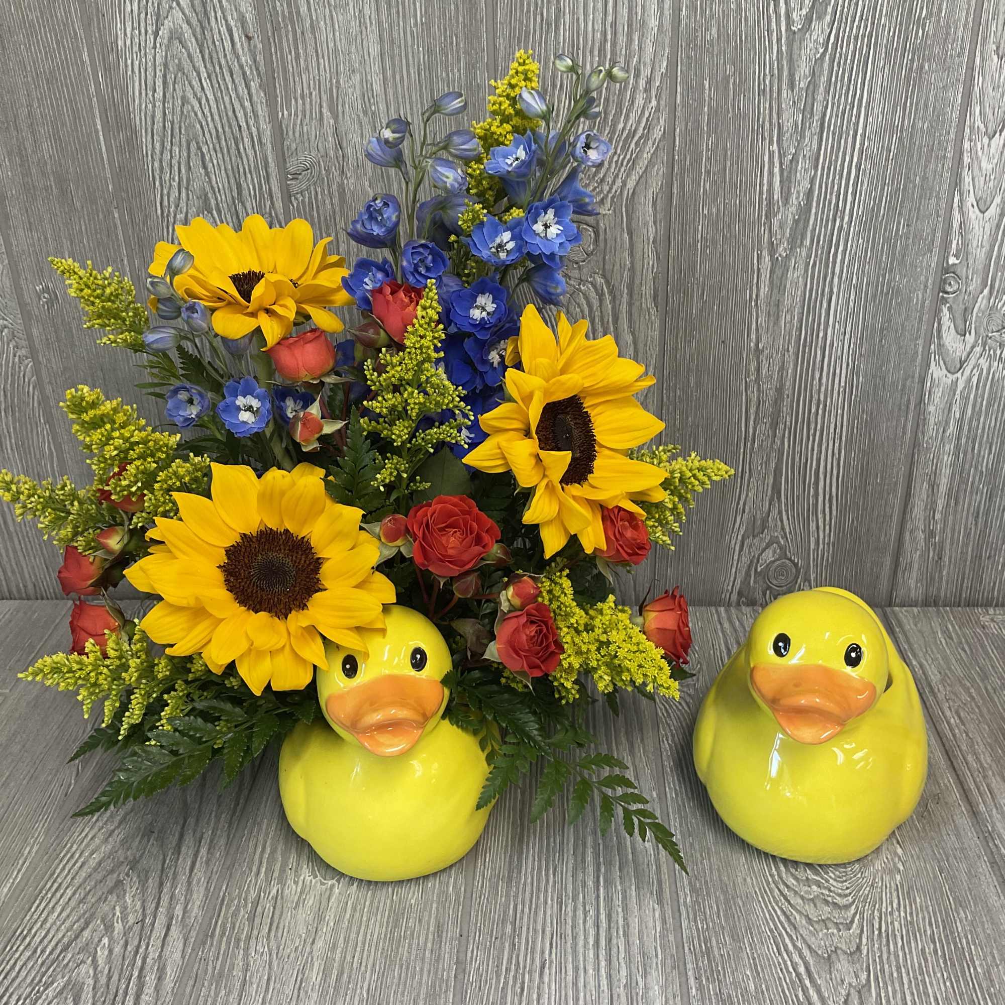 Fresh cut flowers arranged in a keepsake ceramic rubber duck container. Flowers Fresh cut flowers arranged in a keepsake ceramic rubber duck container. Flowers