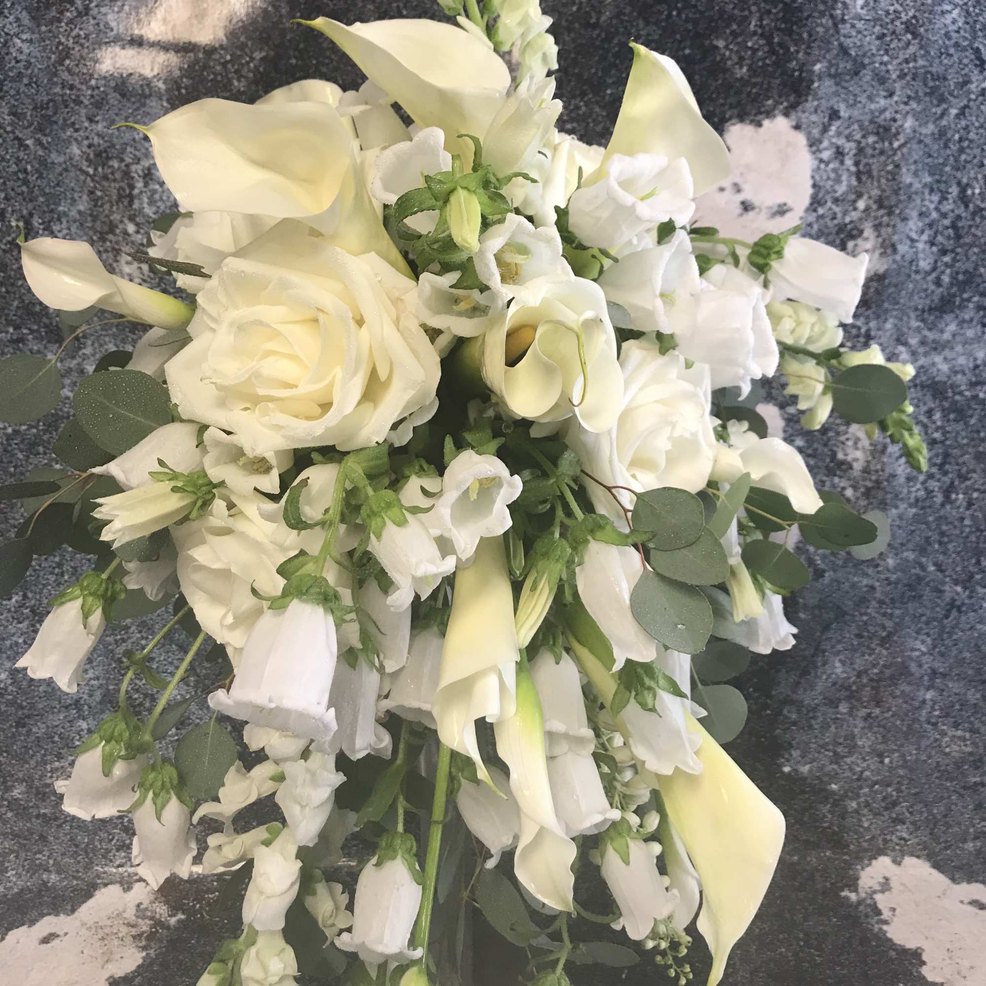 This bouquet is designed with White Roses, White Snapdragons, White Campanulla, White This bouquet is designed with White Roses, White Snapdragons, White Campanulla, White