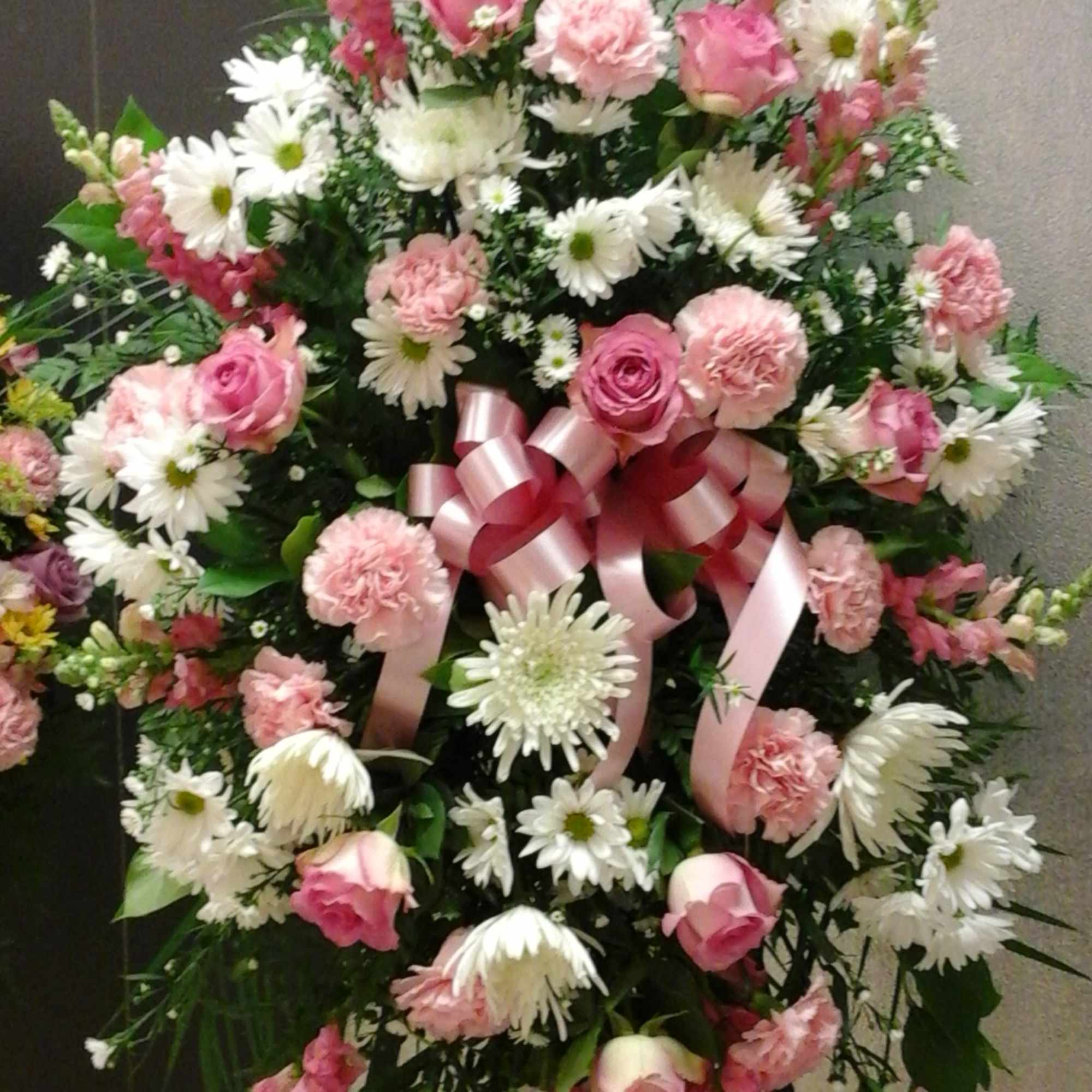 This standing spray make with pink and white colors flower , roses