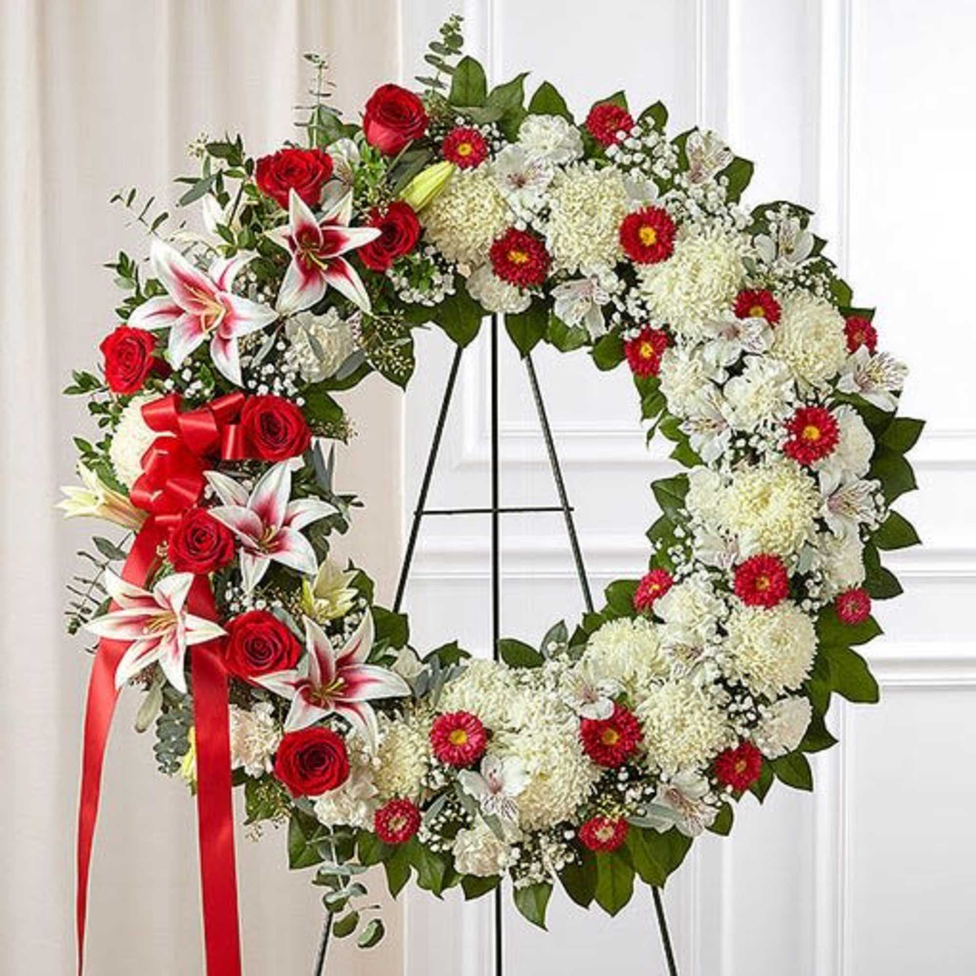 Our timeless standing wreath&mdash;symbolizing the circle of life&mdash;features red roses and Stargazer