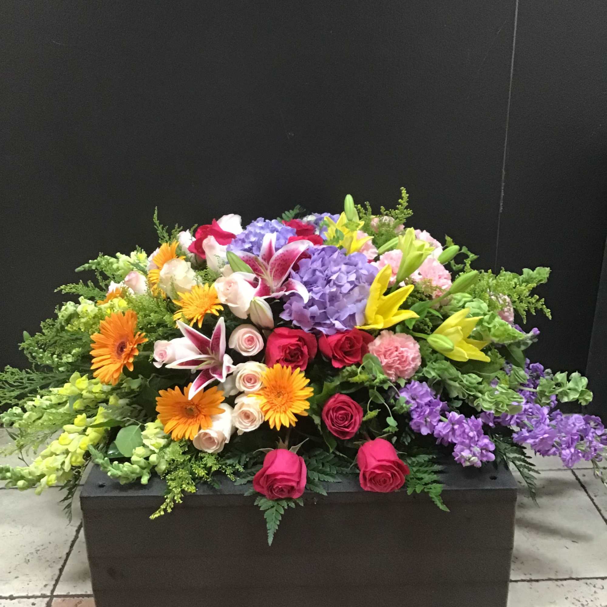 This beautiful casket spray make with lavender hydrangea and stock  