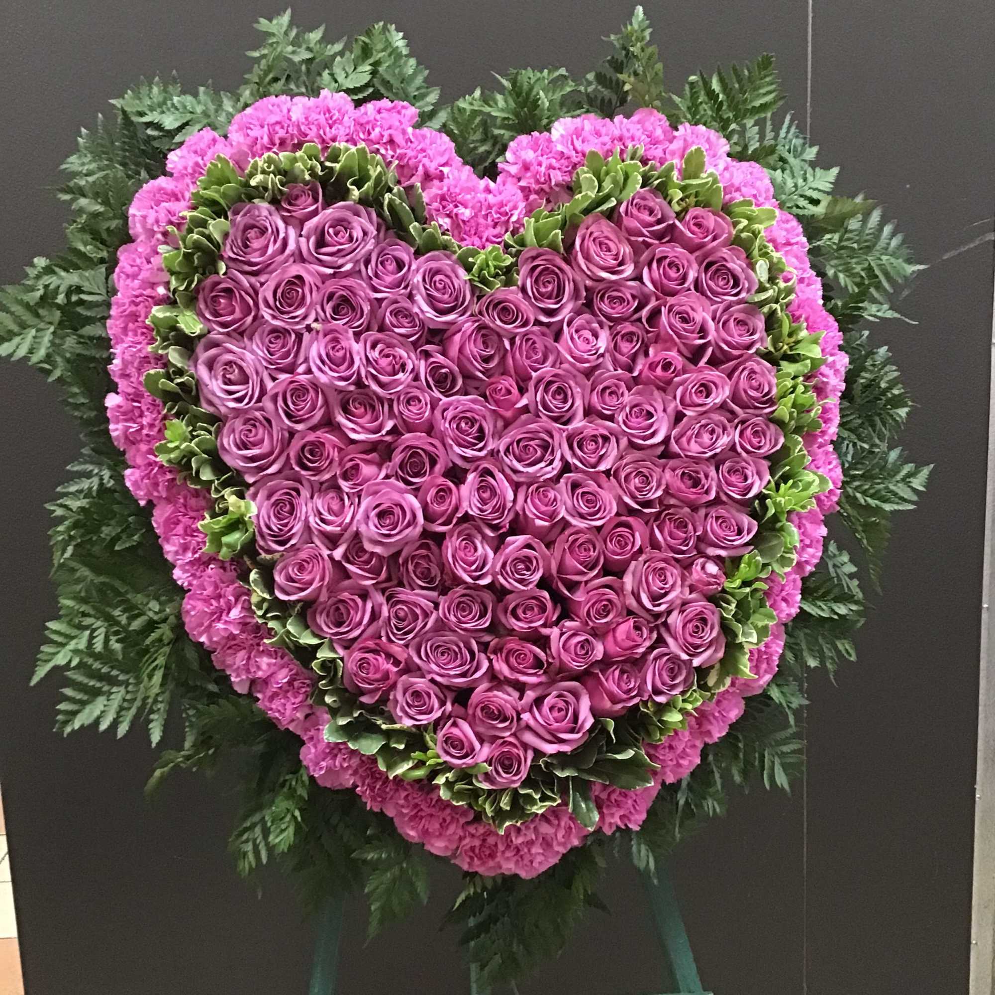 This beautiful Solid Heart make with Roses  and Carnations ,the arrangement.
