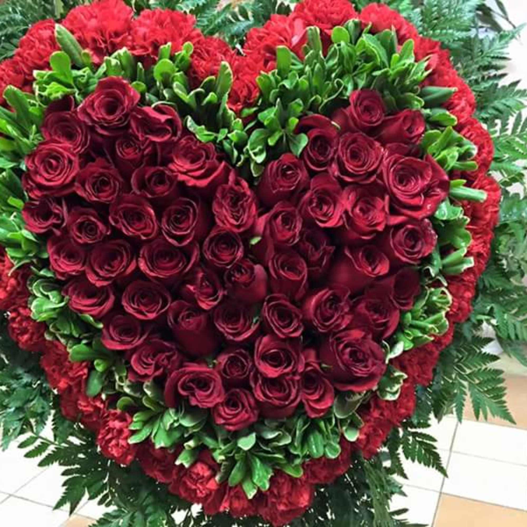 This beautiful Solid Heart make with Roses  and Carnations ,the arrangement.