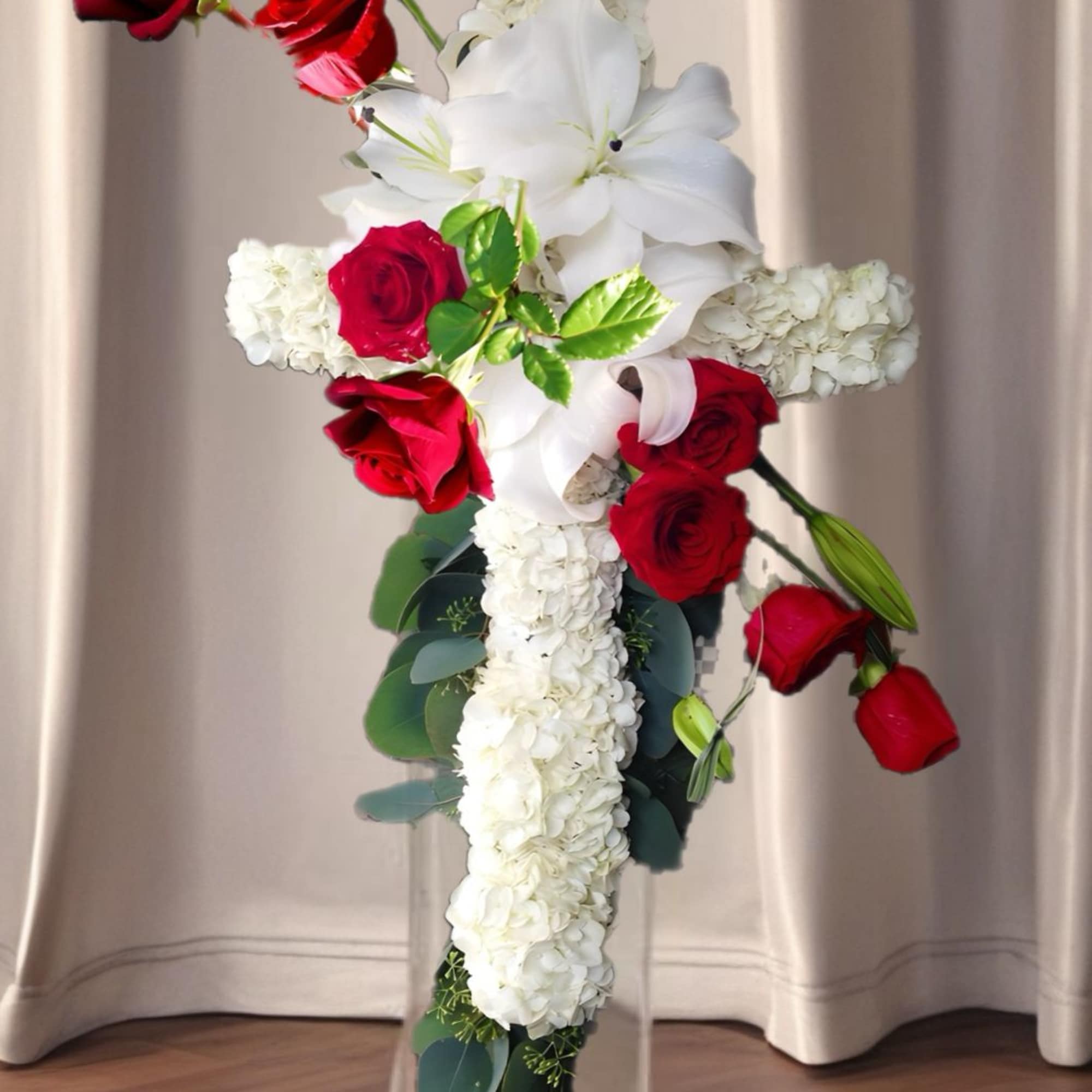 Commemorate fidelity with this standing spray cross of white blossoms adorned with