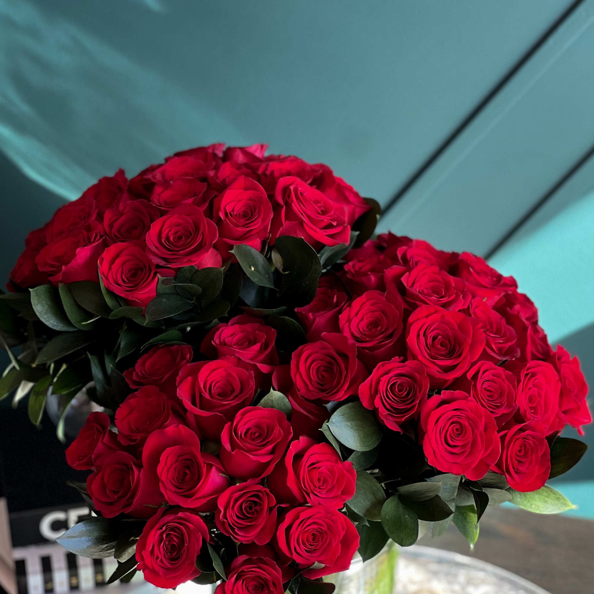 6 dozen fresh cut red roses in clear vase