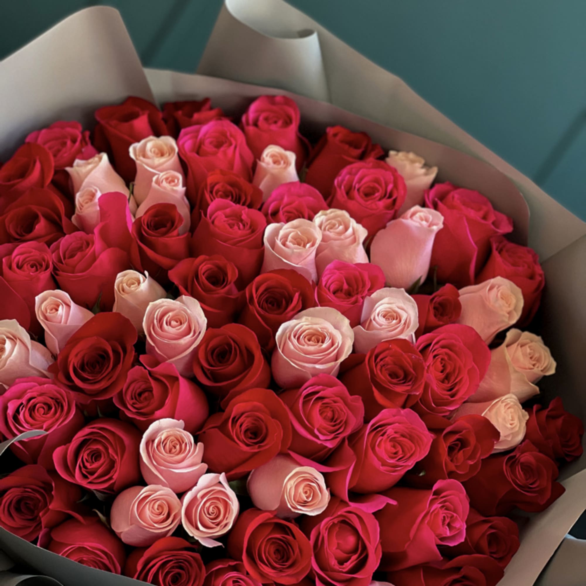 75 Mixed roses. Red, hot pink and pink . Hand-crafted bouquet in