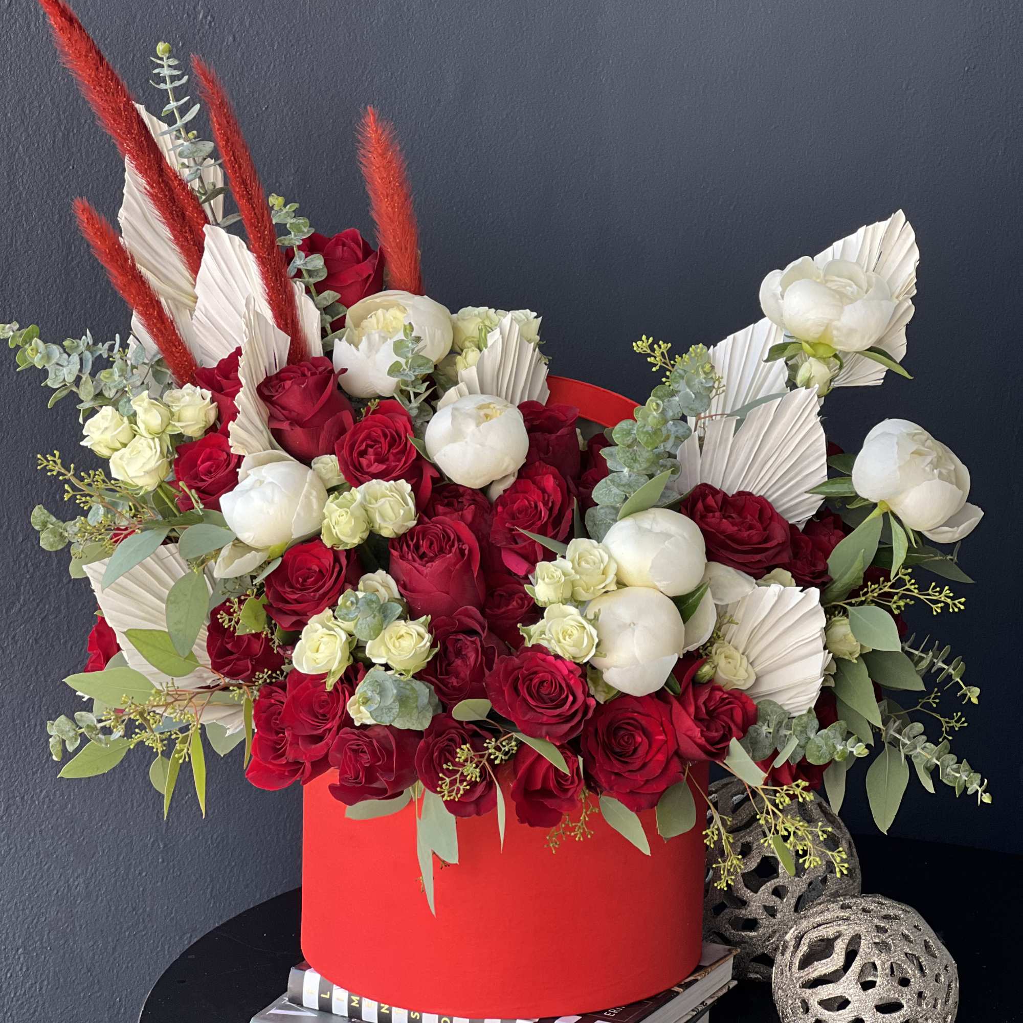 Boxed design in red and white colors. with roses, spray roses and