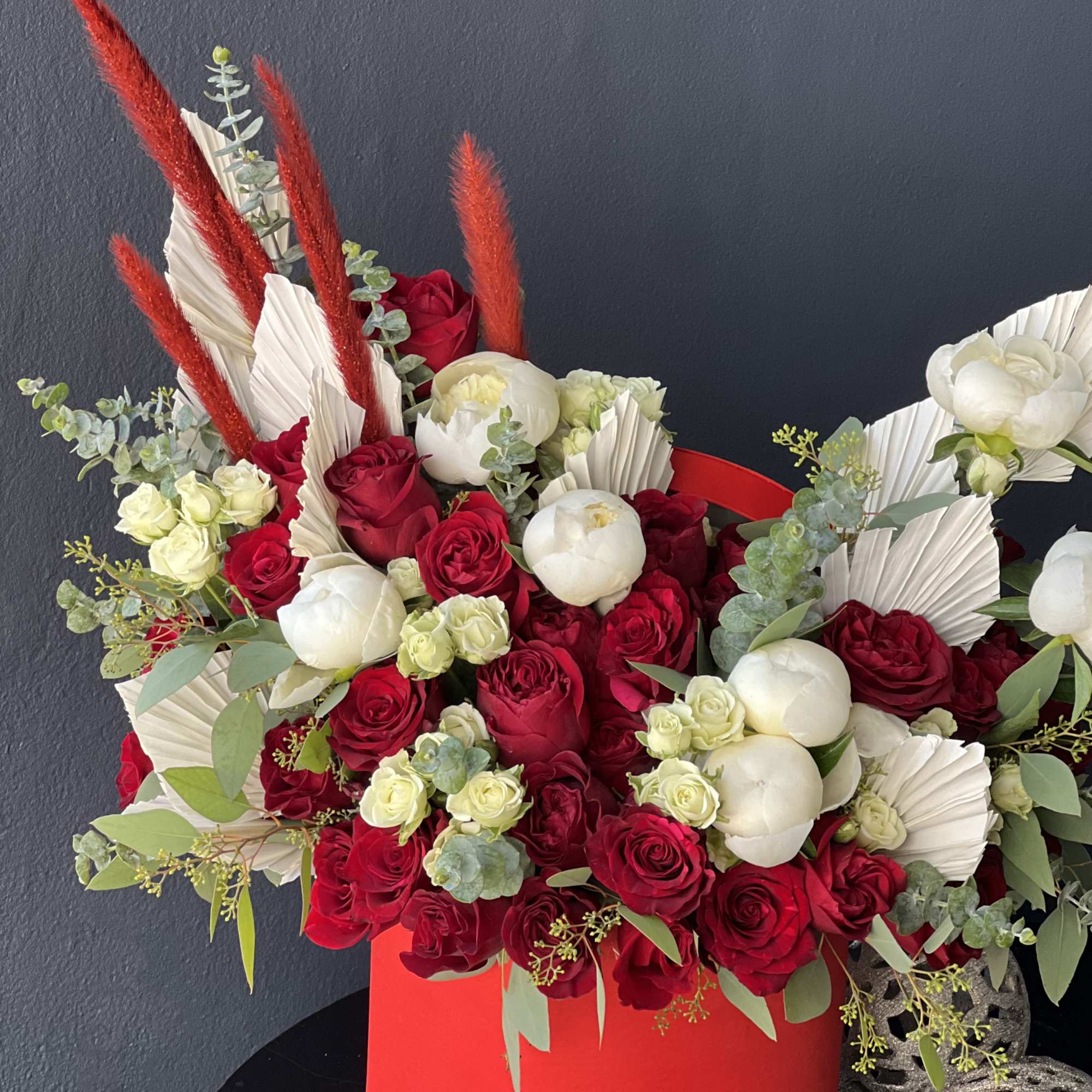 Boxed design in red and white colors. with roses, spray roses and