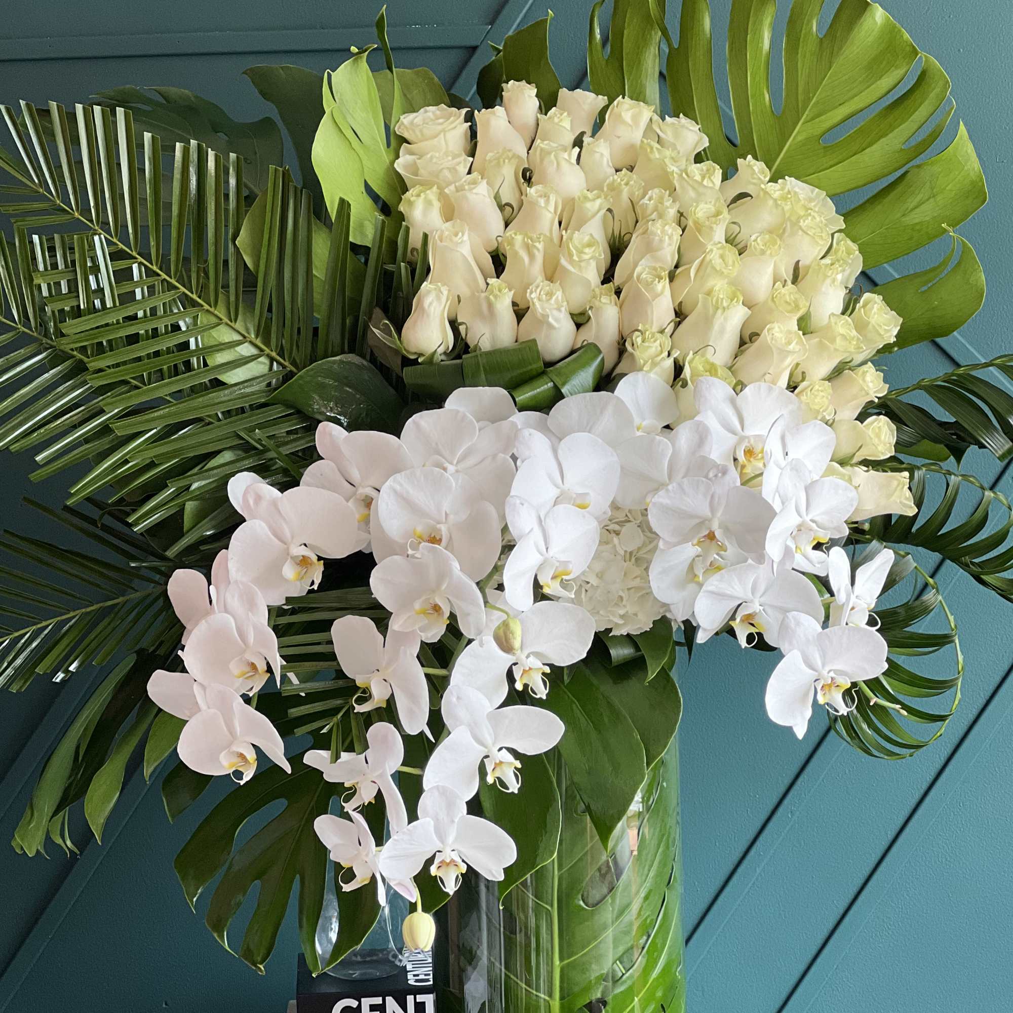 Tall modern design with roses and orchids  
Perfect combination of white